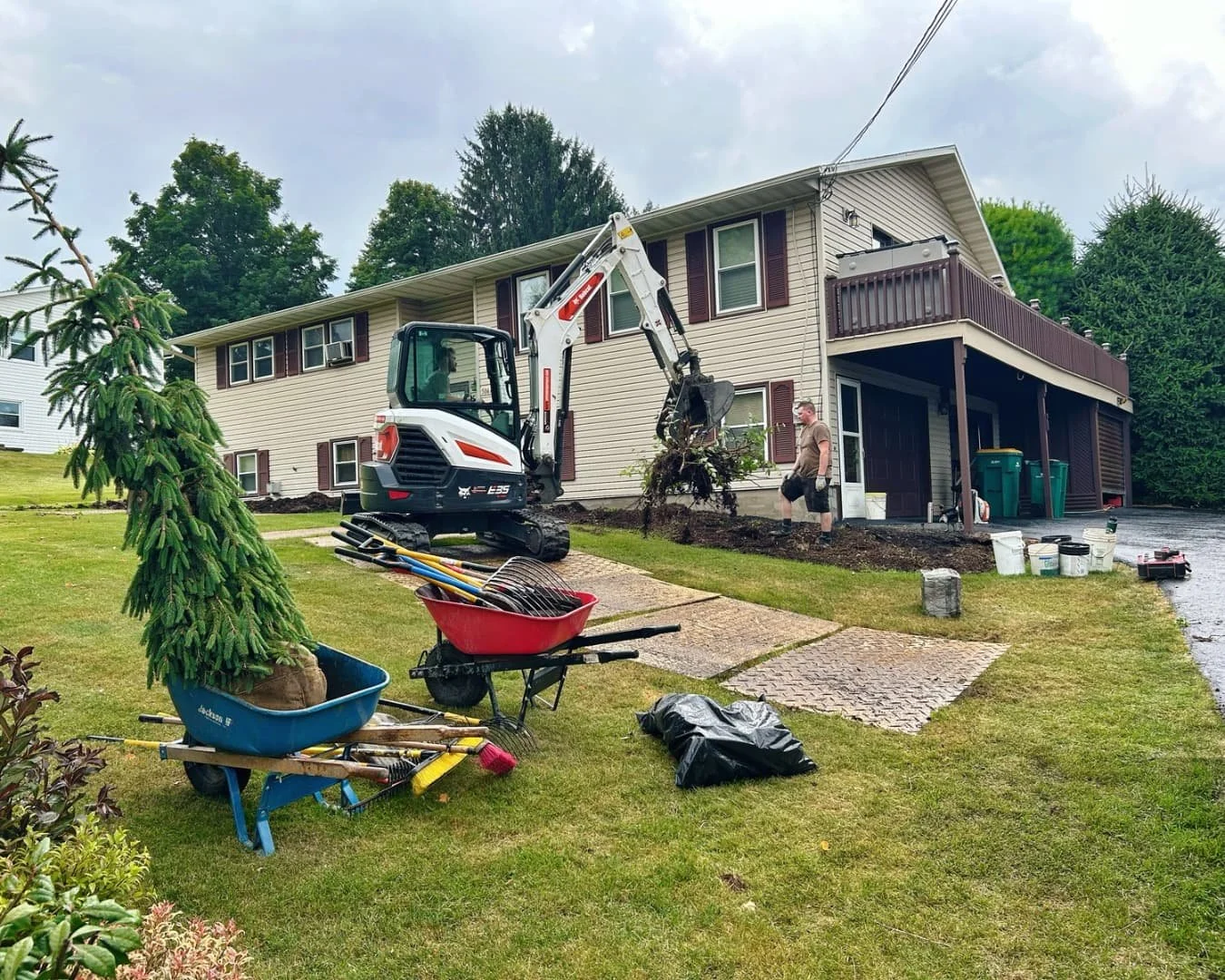 Home exterior and yard before landscaping by Pines and Pavers in Upstate New York.