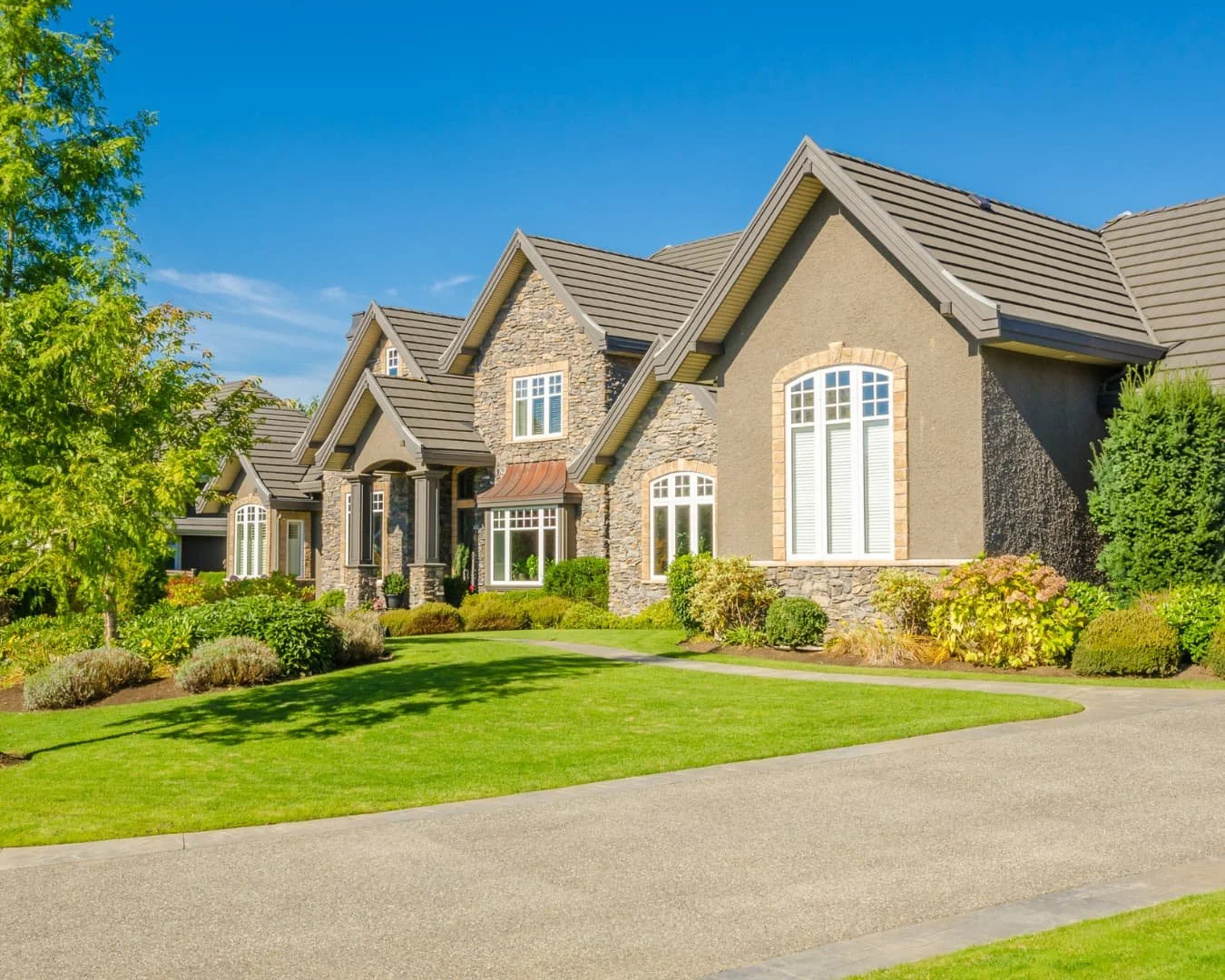 appeal inspiration with a manicured front lawn, layered planting, and a polished residential entry.