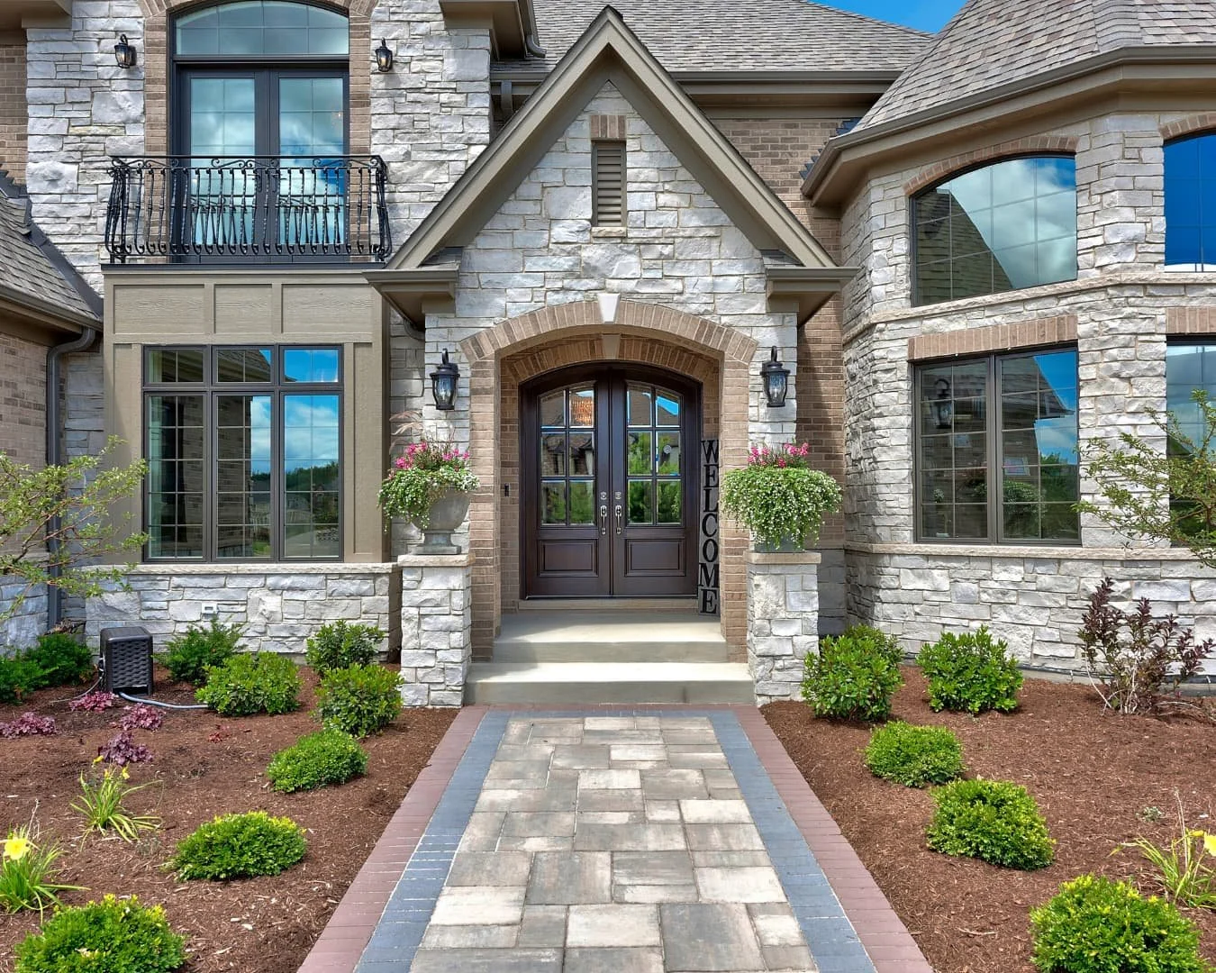 Walkway inspiration showing a gently curved garden path framed by foundation planting and seasonal color.