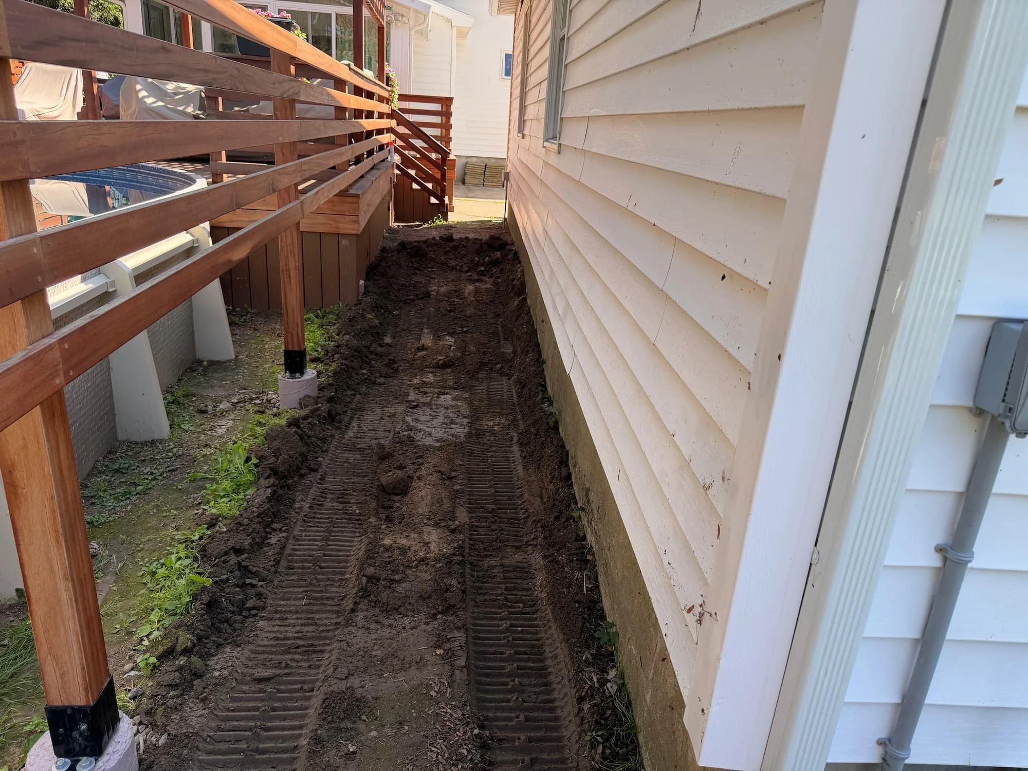 Backyard lawn and deck area before landscape renovation work in Central New York.
