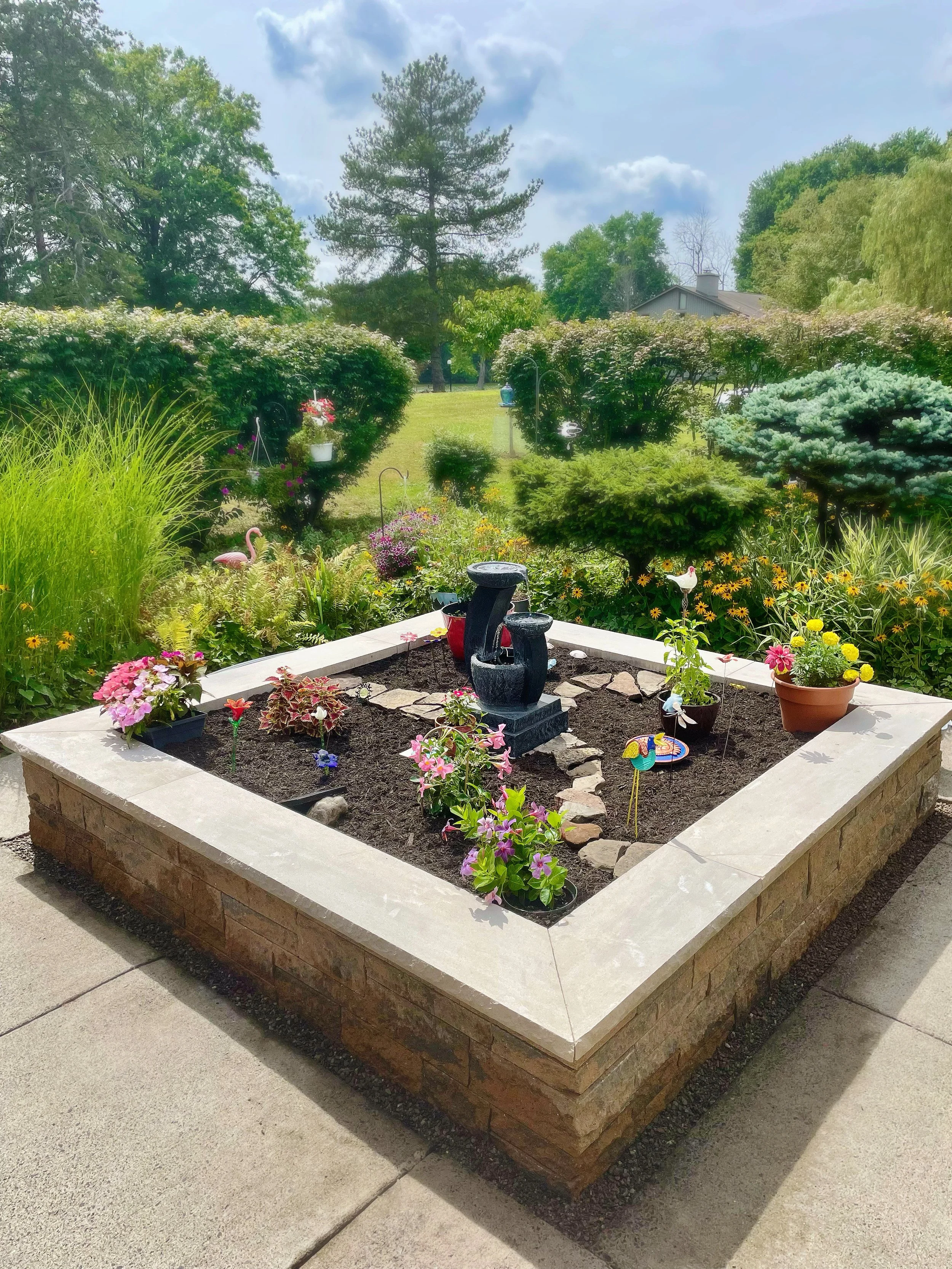 Custom raised garden bed with stone edging in Central New York
