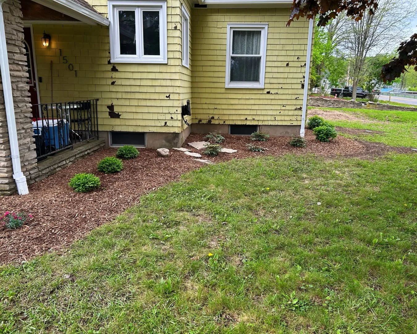 Front foundation planting bed and entry area completed by Pines and Pavers in Central New York.