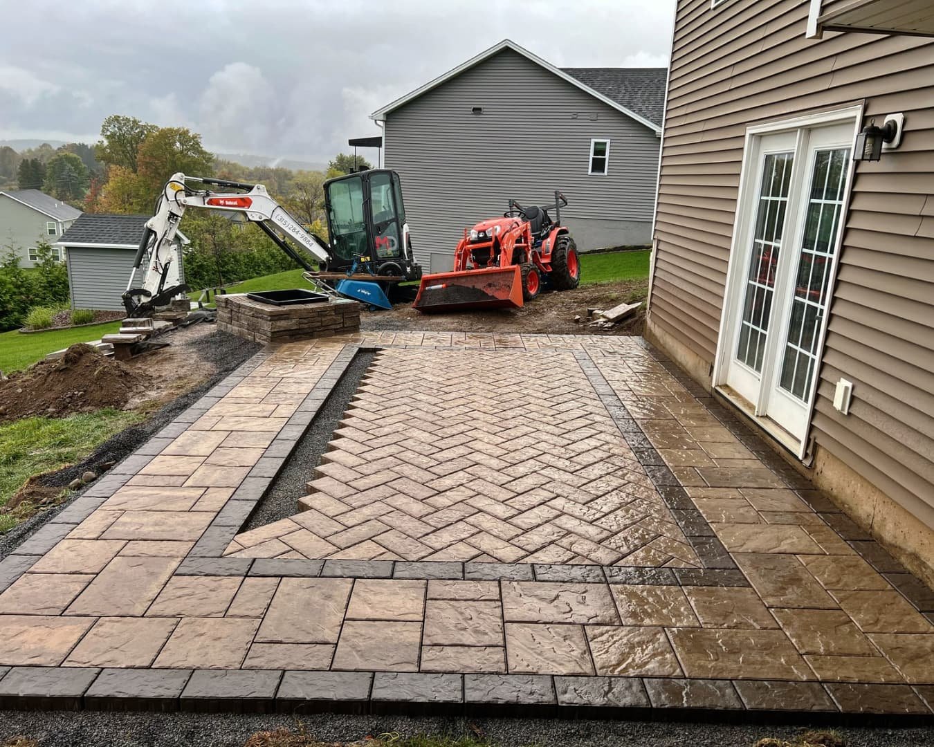 Backyard paver patio overview completed by Pines and Pavers in Lysander, New York.