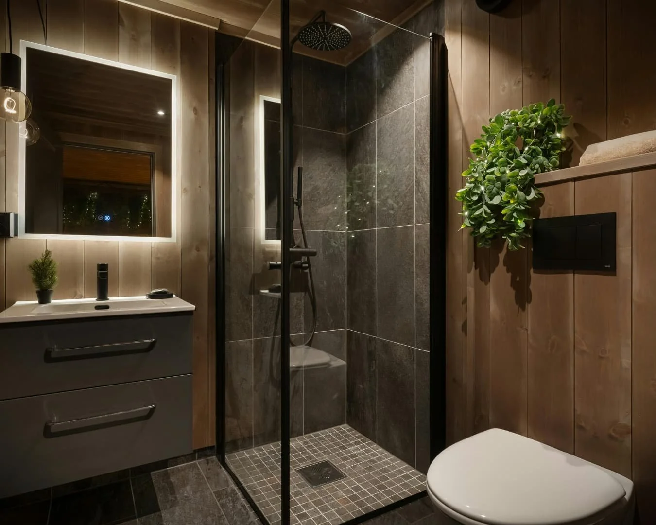 Bathroom inspiration with a dark walk-in shower, modern vanity, and moody upscale finishes.