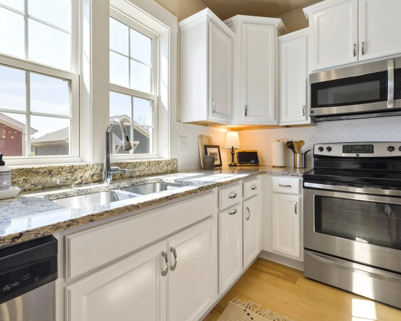 Kitchen inspiration featuring a bright galley-style remodel with light cabinetry and stainless appliances.