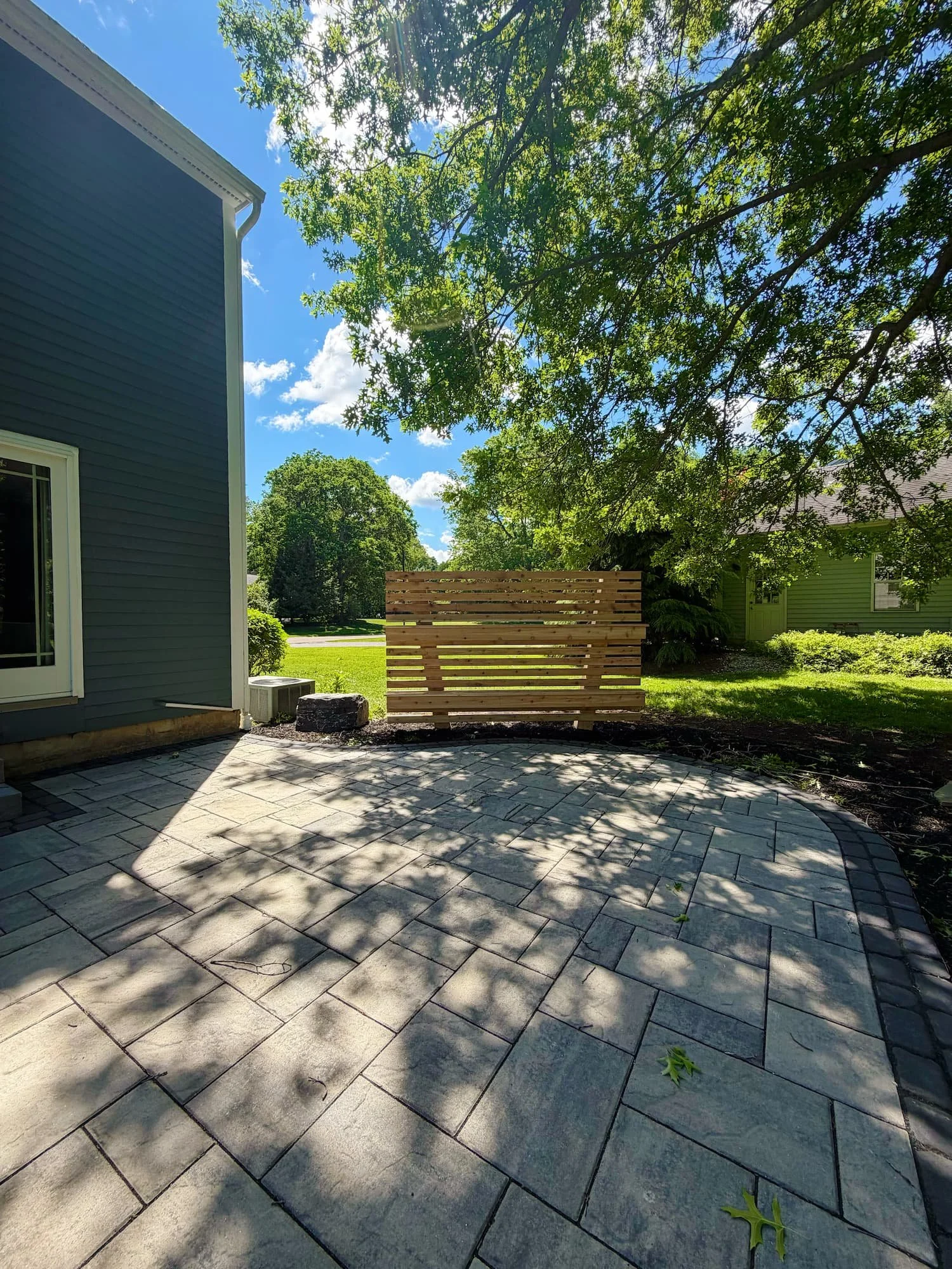 Professionally installed paver patio and walkway connecting the backyard outdoor space to a Central New York home.