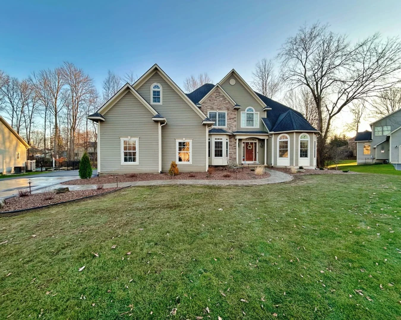 Wide front yard landscape overview completed by Pines and Pavers in Fayetteville, New York.