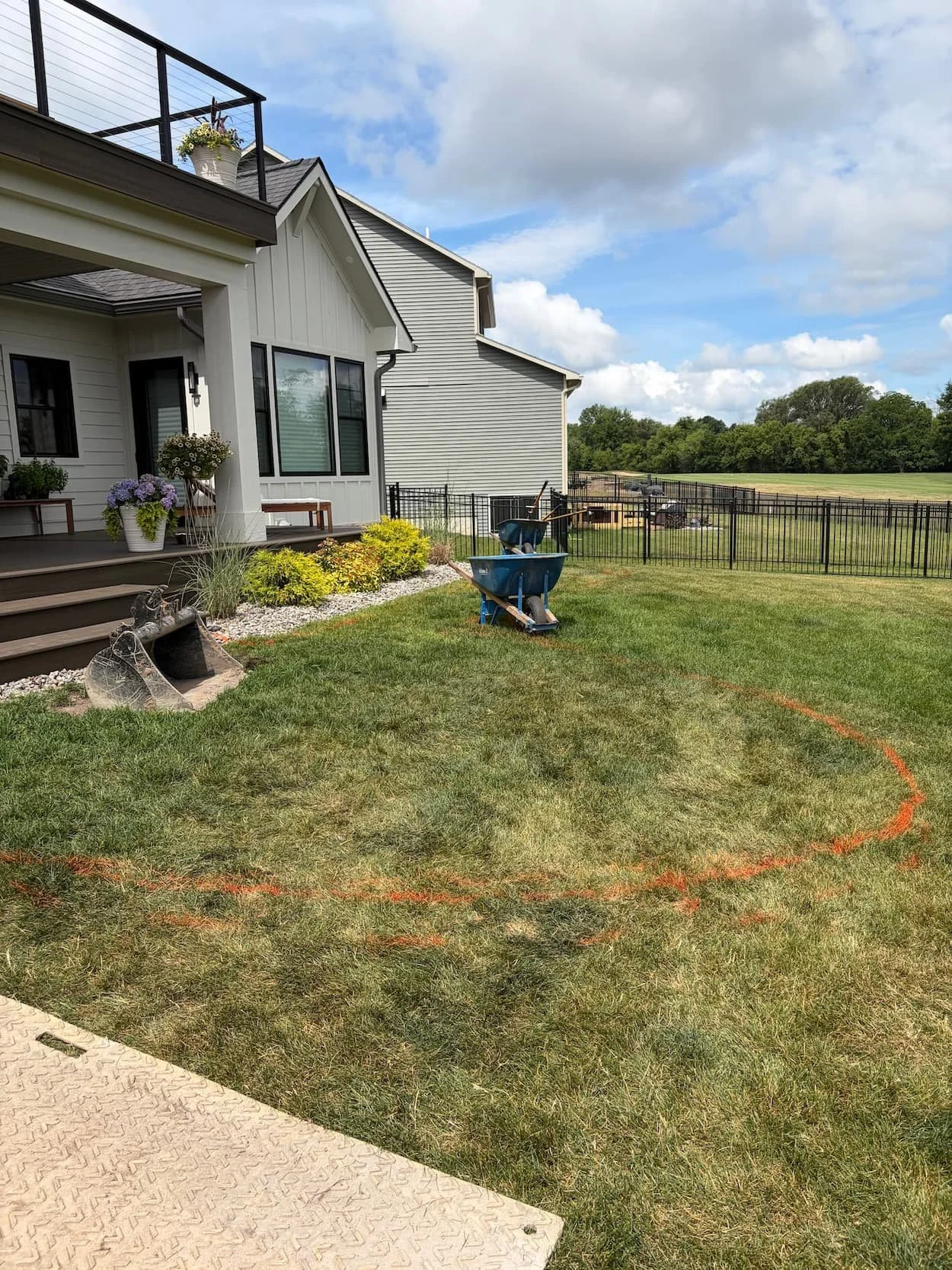 Residential landscaping before renovation with existing lawn and foundation plantings in Central NY