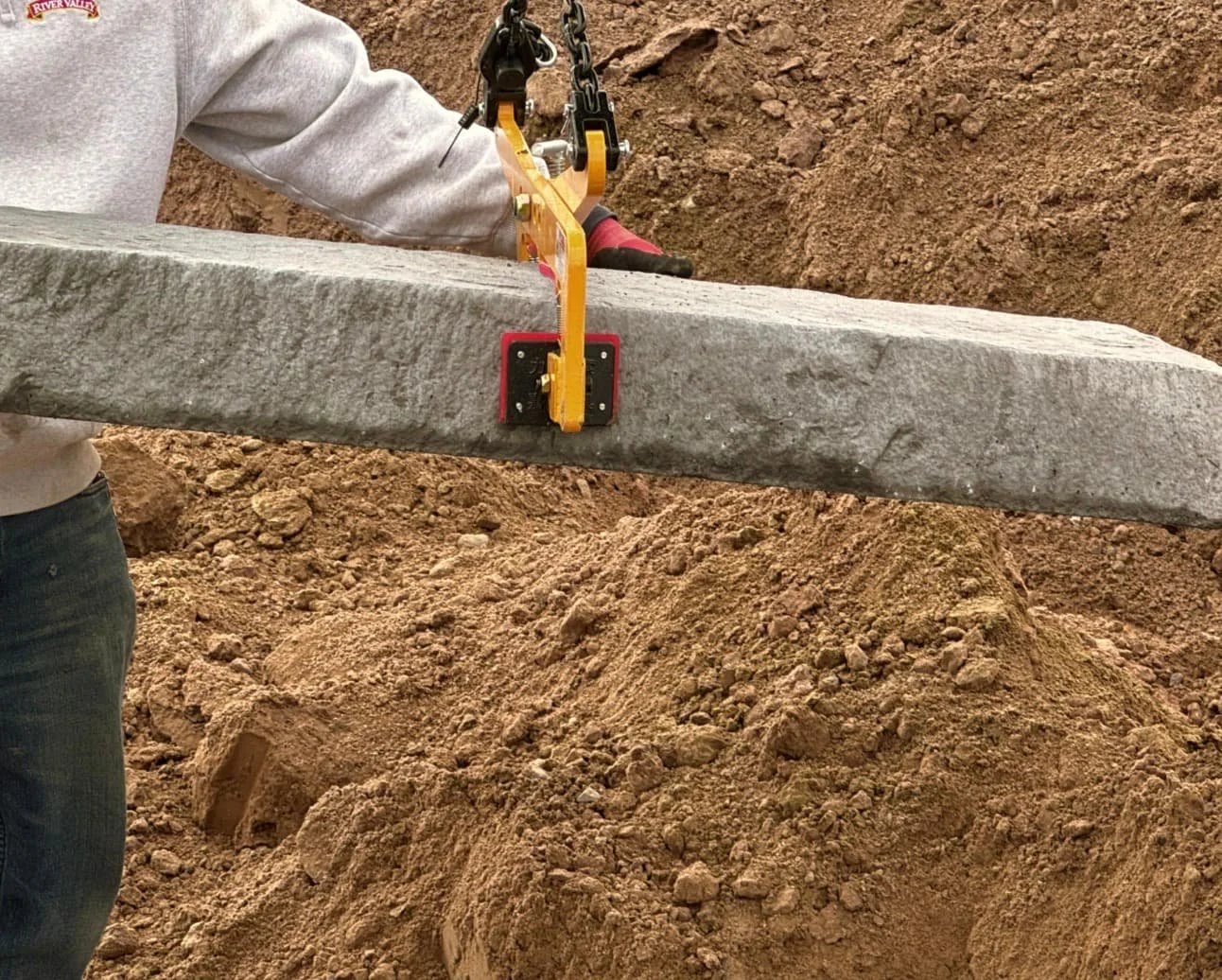 Front steps under construction at a Central New York home with retaining walls and fresh hardscape grading.