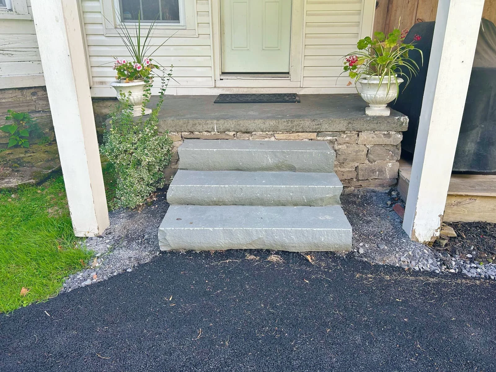 Custom stone front entry steps and walkway installed by Pines and Pavers in Central New York. 