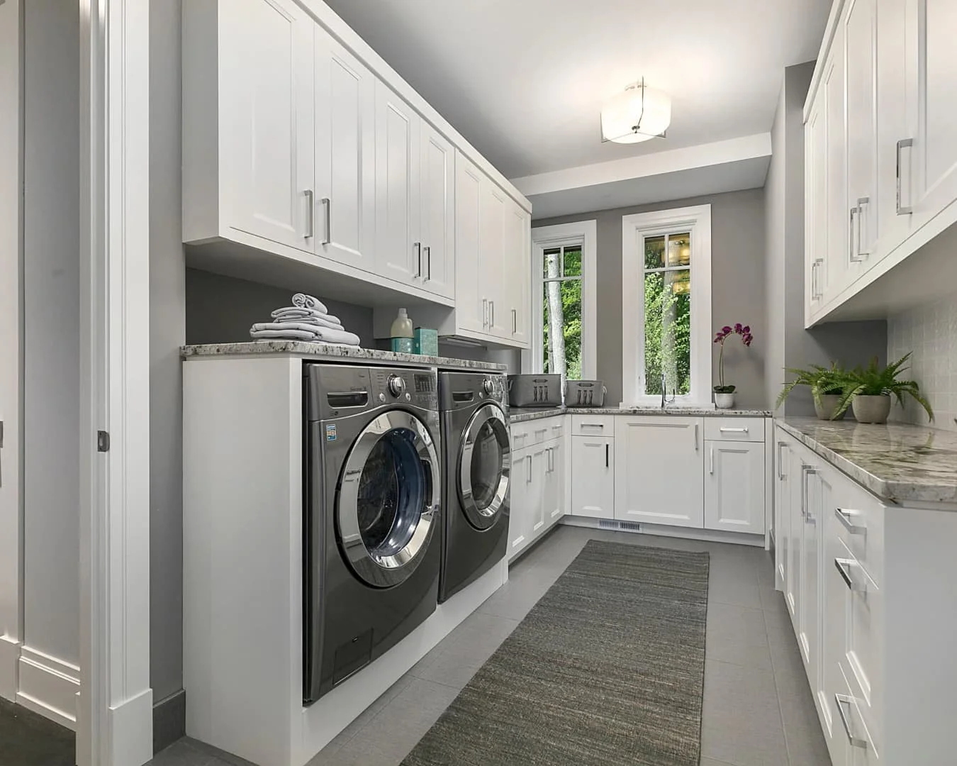 Mudroom inspiration showing a narrow laundry and storage layout with cabinetry and built-in function.
