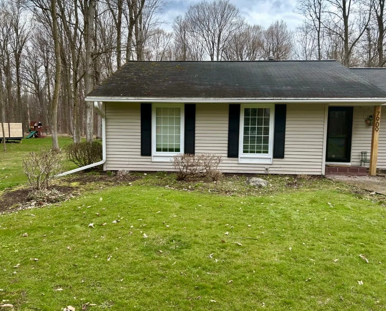 Front entry landscape path at a Cazenovia, NY home with decorative stone, mulch beds, and tidy shrub placement.