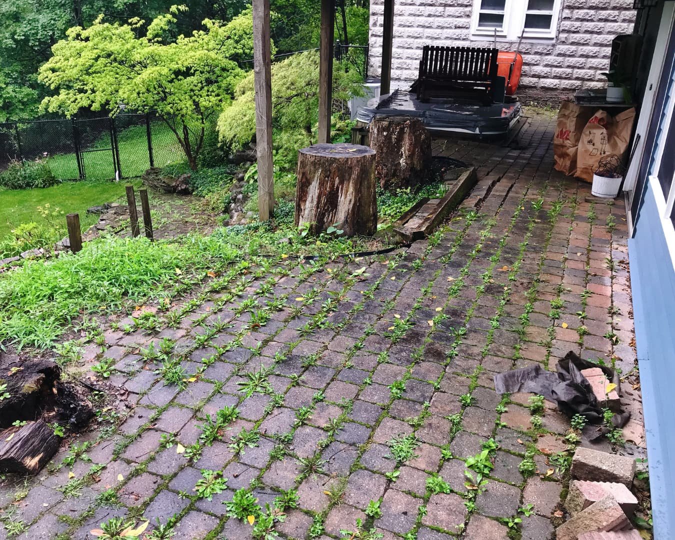 Existing covered patio and hot tub area before renovation by Pines and Pavers in Central New York.