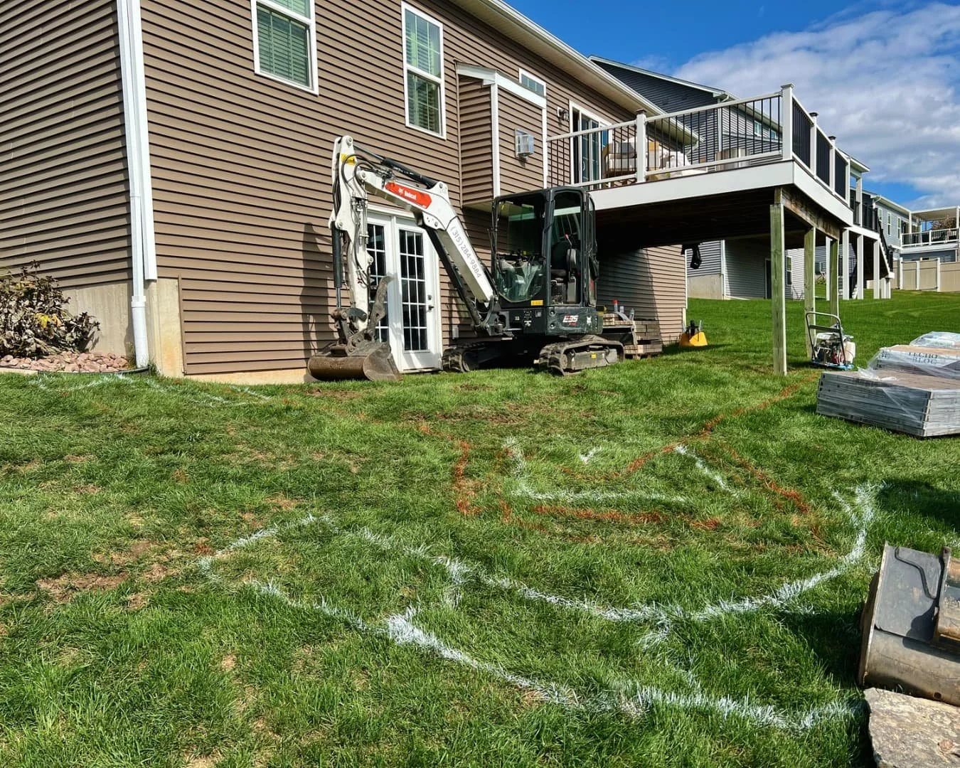 Rear yard site preparation in progress by Pines and Pavers in Lysander, New York.