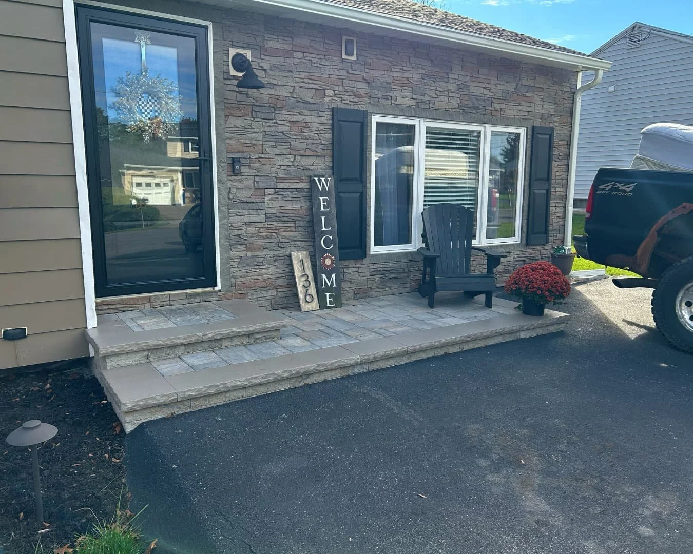 Front entry paver patio with seating completed by Pines and Pavers in Camillus, New York.