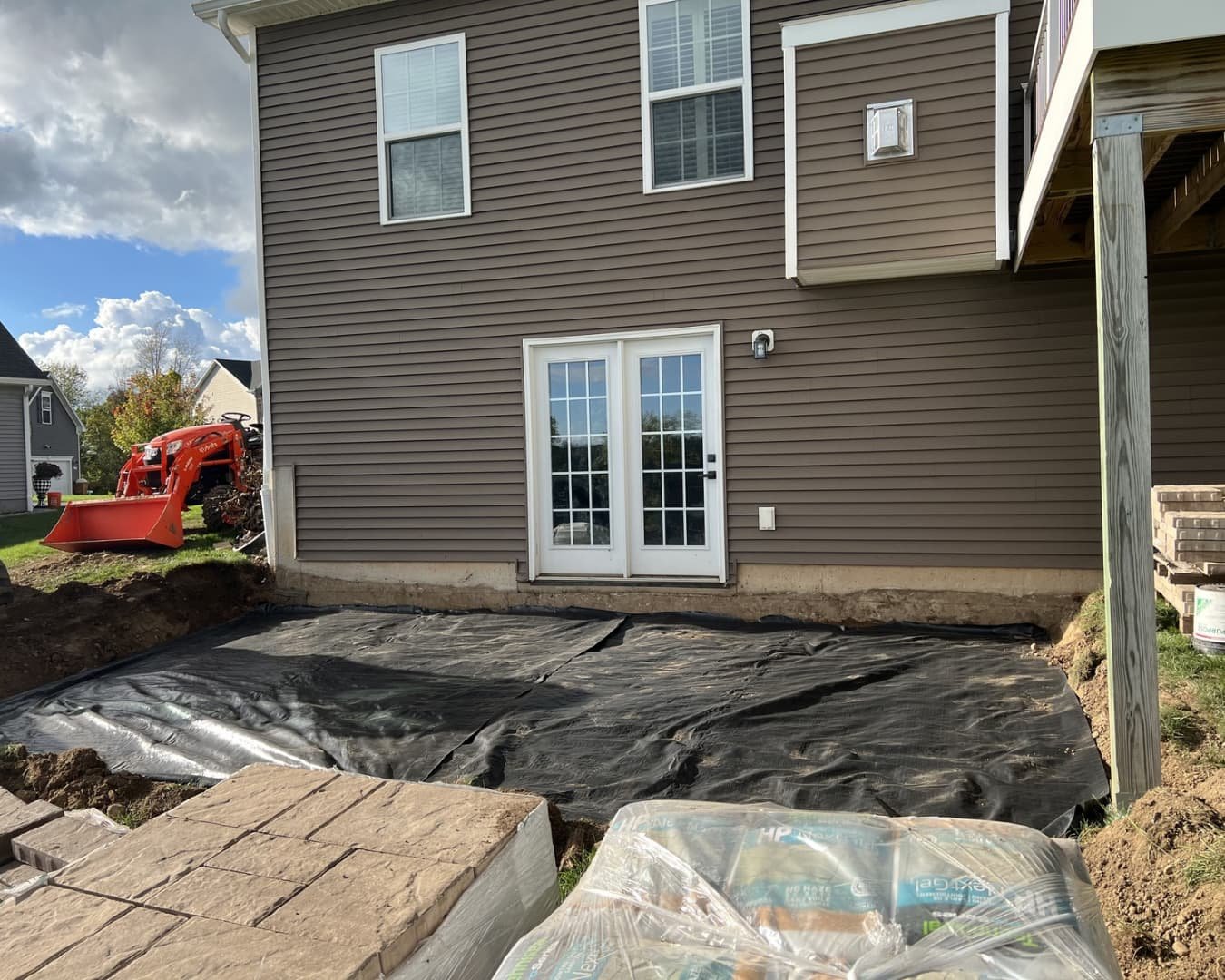 Excavation and site preparation for patio construction at a Central New York residential property.