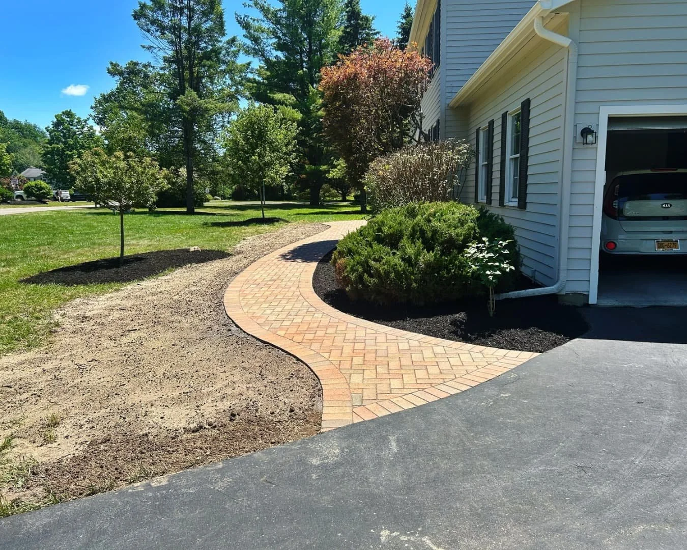 Curved front entry walkway completed by Pines and Pavers in Manlius, New York.