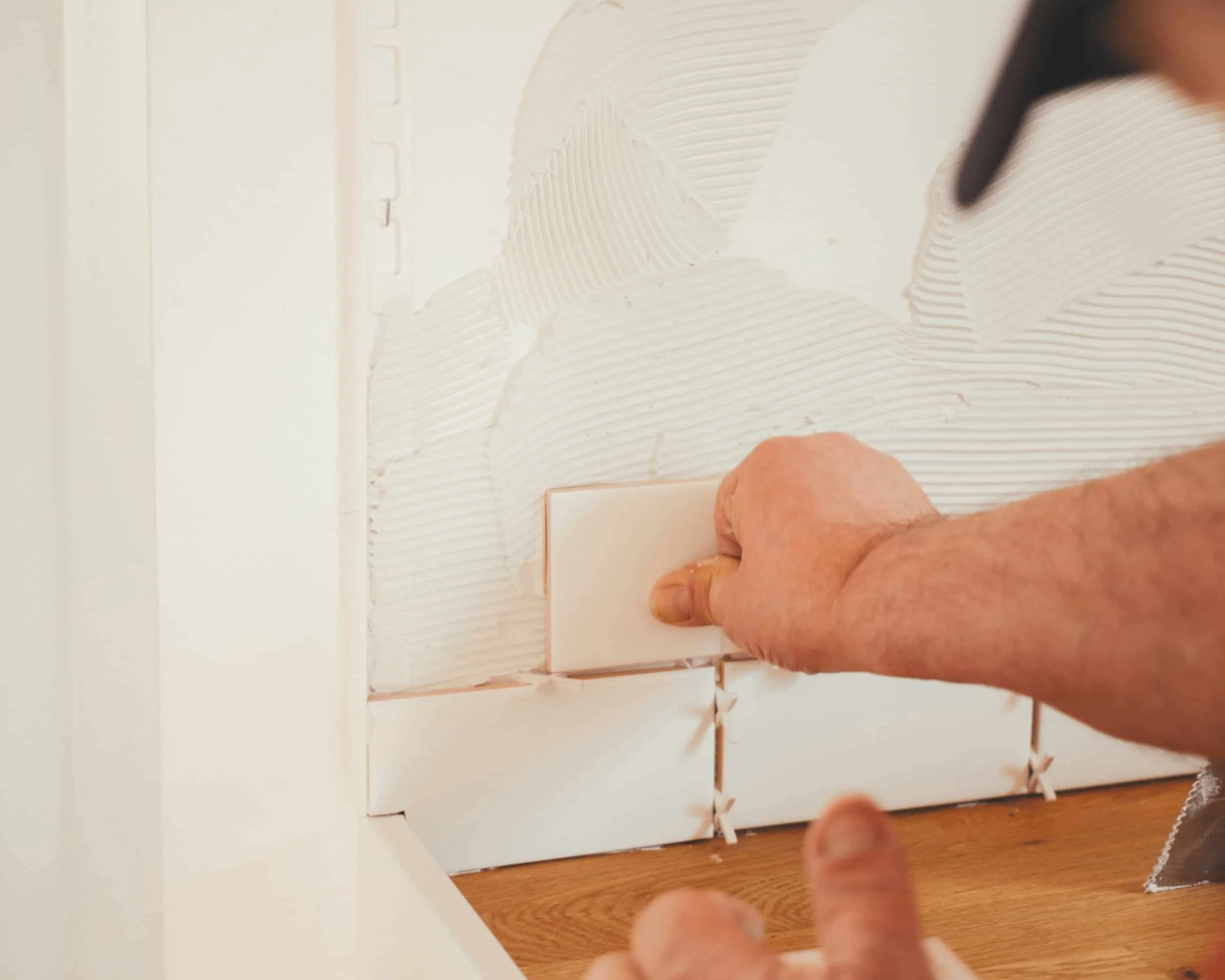 Subway tile backsplash installation during kitchen renovation