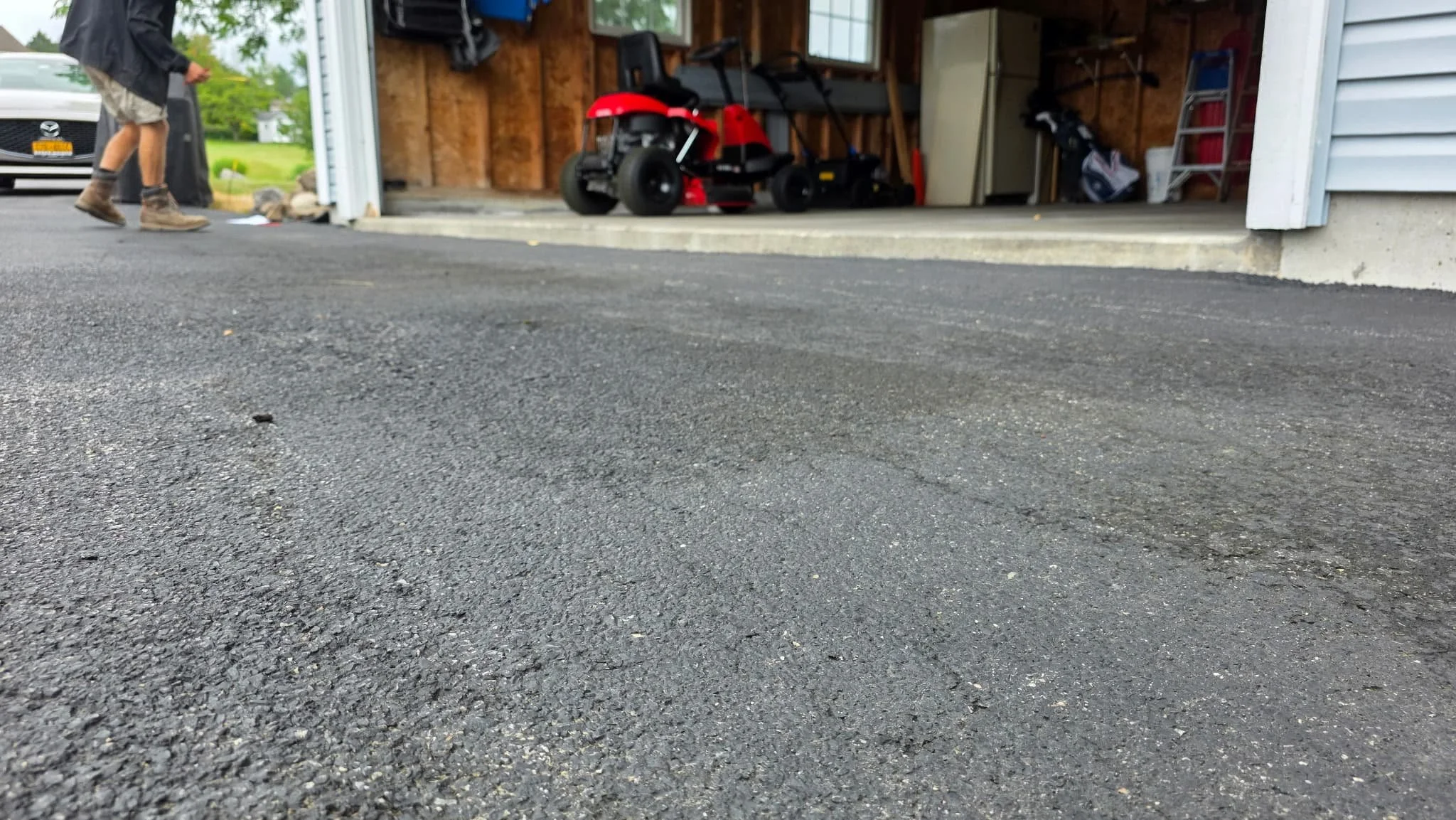 Before view of the driveway and garage entrance prior to repair work in Central New York.
