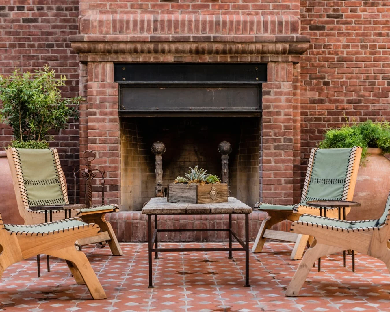 Outdoor fireplace inspiration with a brick fireplace and patio seating arranged for conversation.