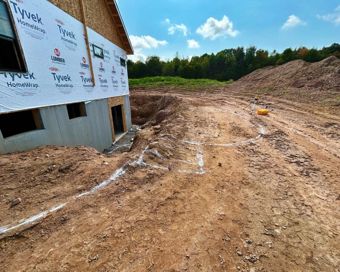 Rear yard grade preparation beside the foundation by Pines and Pavers in Cazenovia, New York.