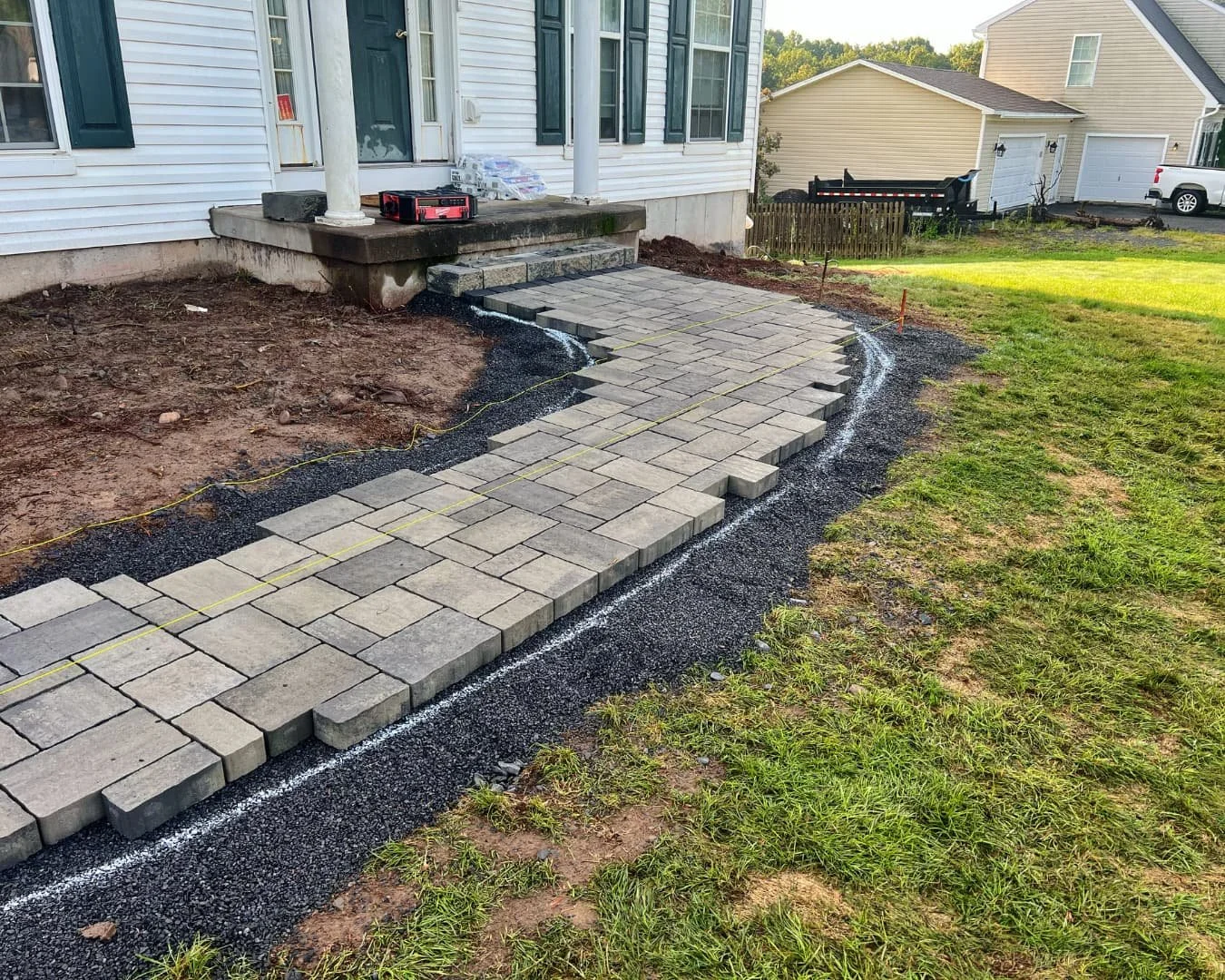 Paver patio installation in progress by Pines and Pavers in Baldwinsville, New York.