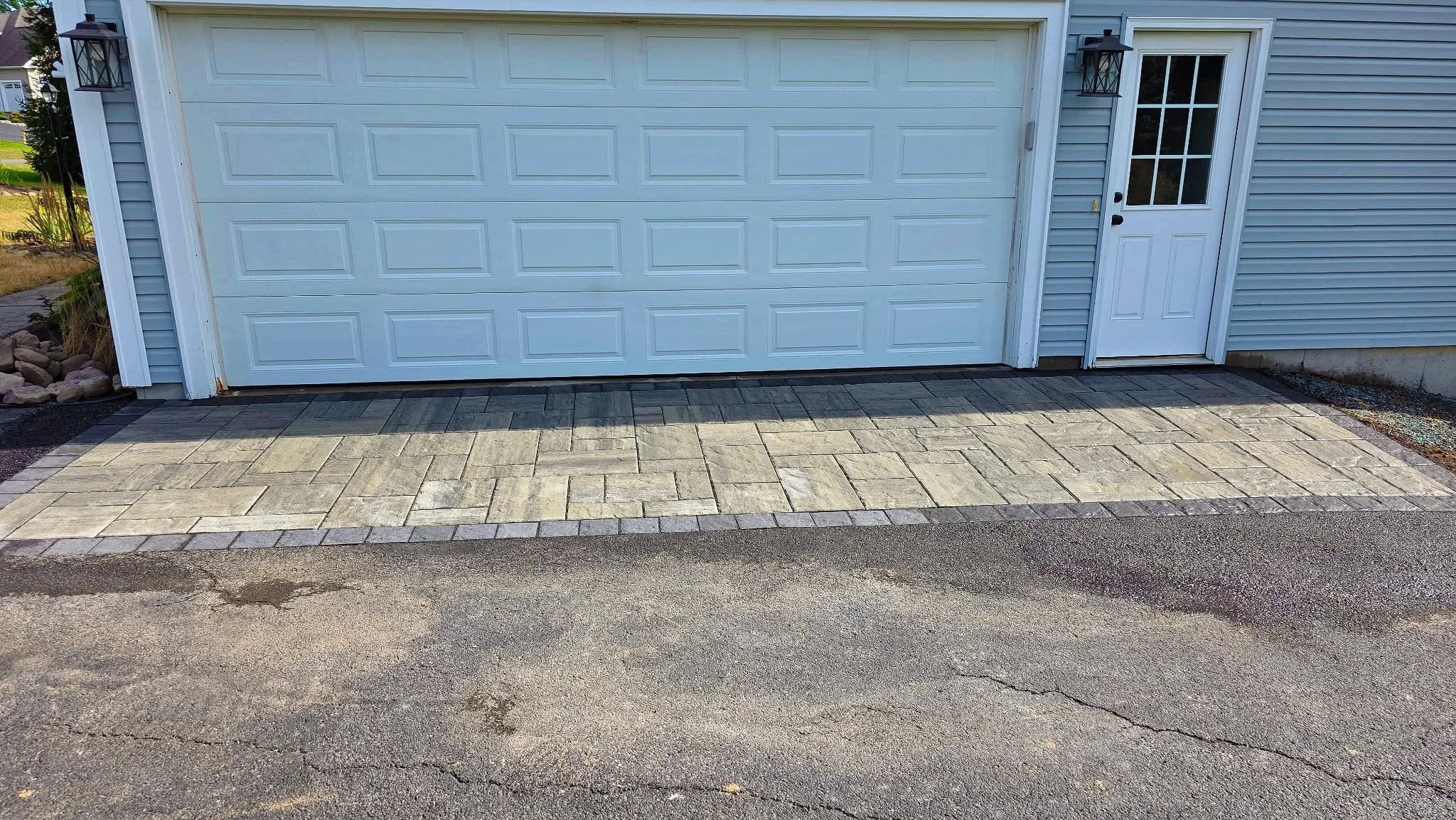 Finished concrete driveway installation connecting to an existing residential driveway in Central New York.