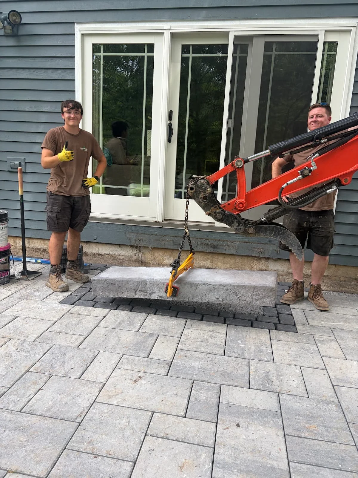 Custom backyard paver patio under construction by Pines and Pavers in Central New York.