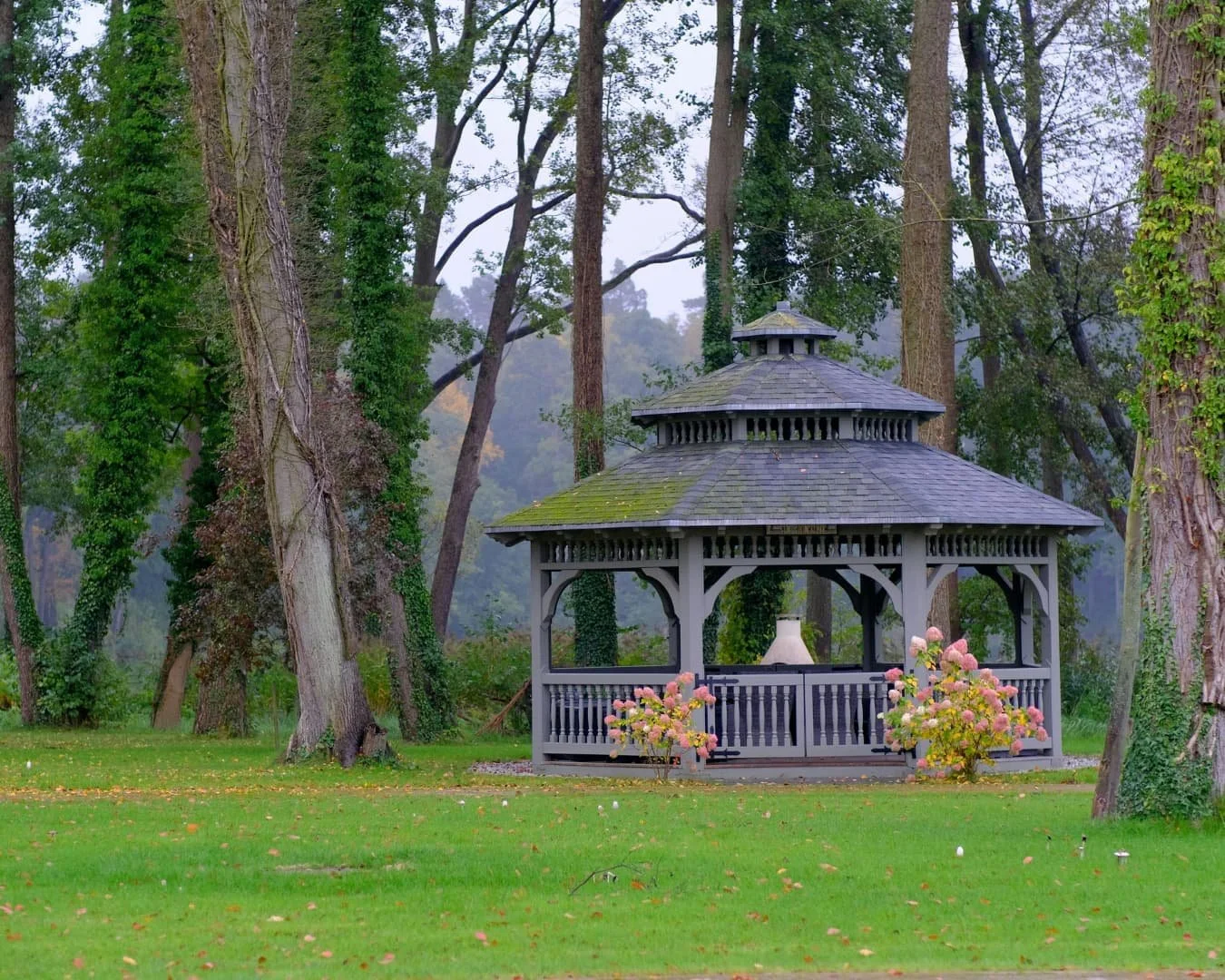 Carpentry inspiration featuring a dark gazebo structure in a wooded landscape setting.