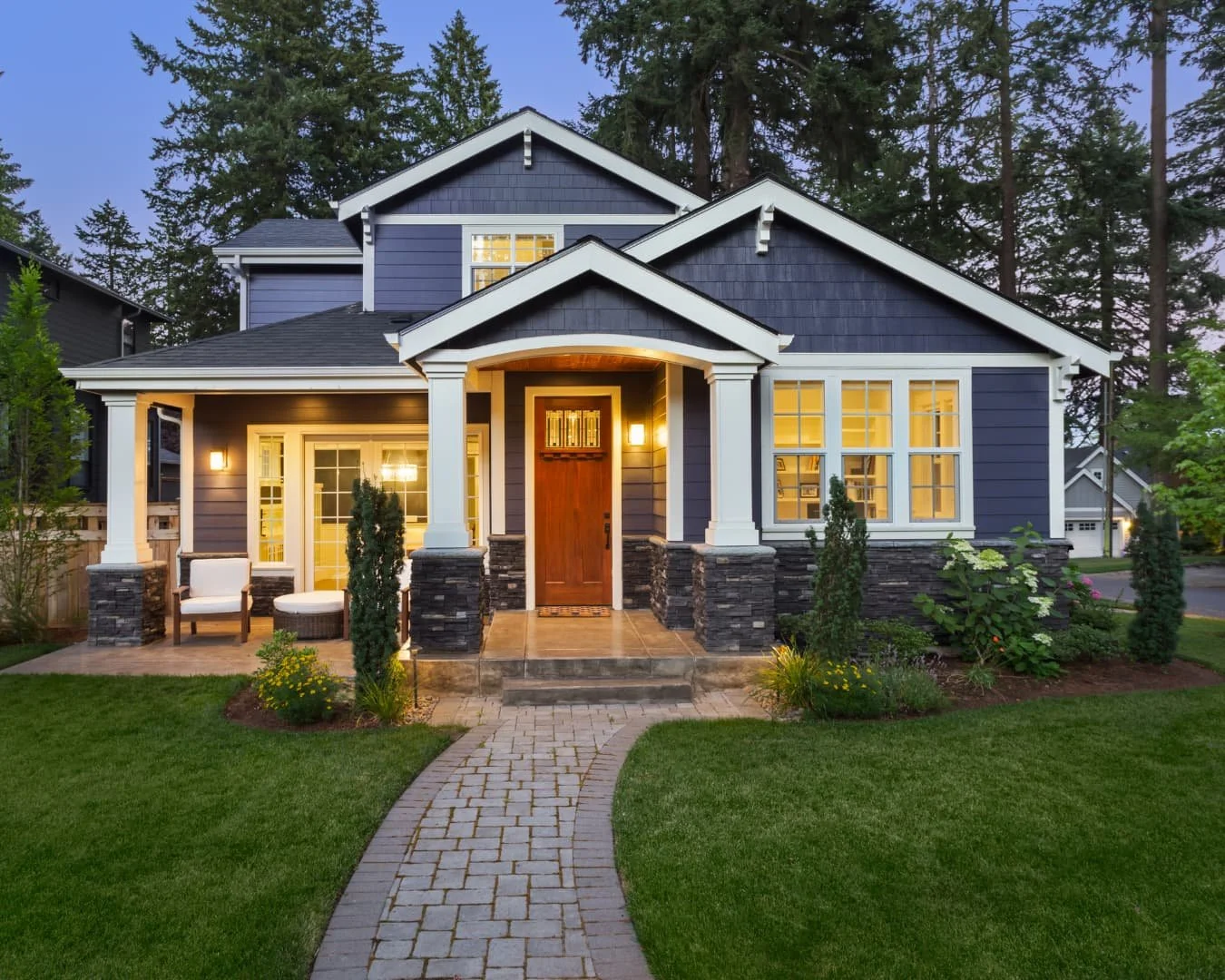 Curb appeal inspiration featuring a large front yard with foundation planting and a refined entry approach.