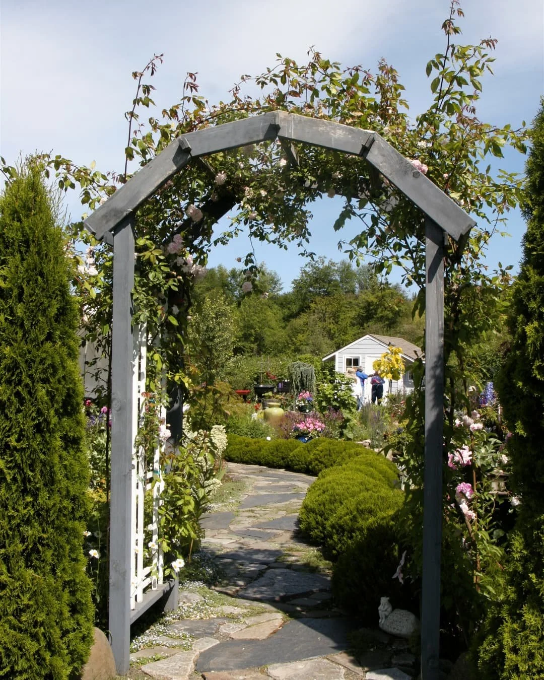 Carpentry inspiration with a larger greenhouse structure framed by planting beds and garden space.
