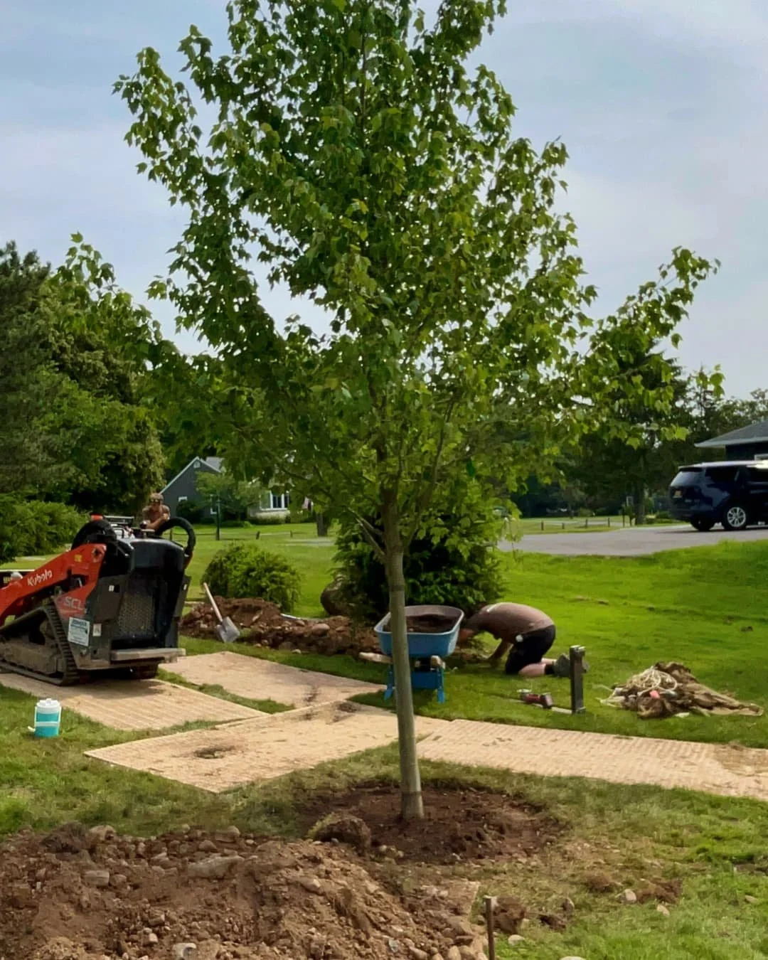 Front yard landscape installation in progress by Pines and Pavers in Skaneateles, New York.