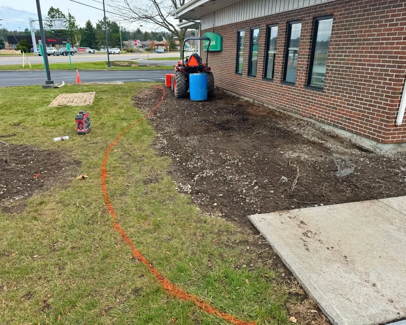 Side bed grading and preparation at Citizens Bank by Pines and Pavers in Cicero, New York.