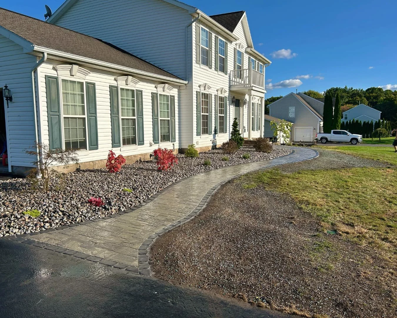 Paver entry and river rock landscape overview completed by Pines and Pavers in Baldwinsville, New York.
