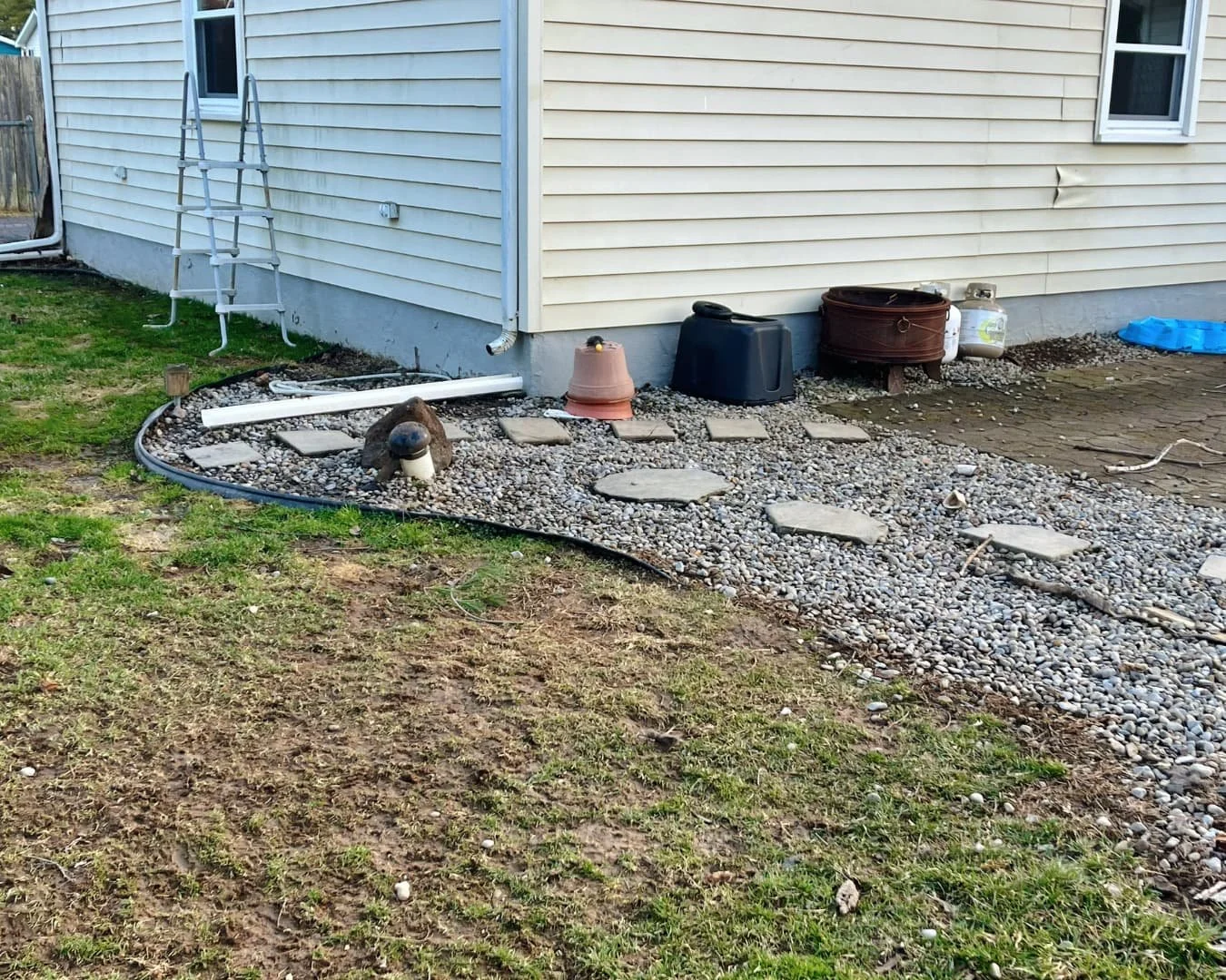 Side yard before landscape and walkway installation by Pines and Pavers in Central New York.