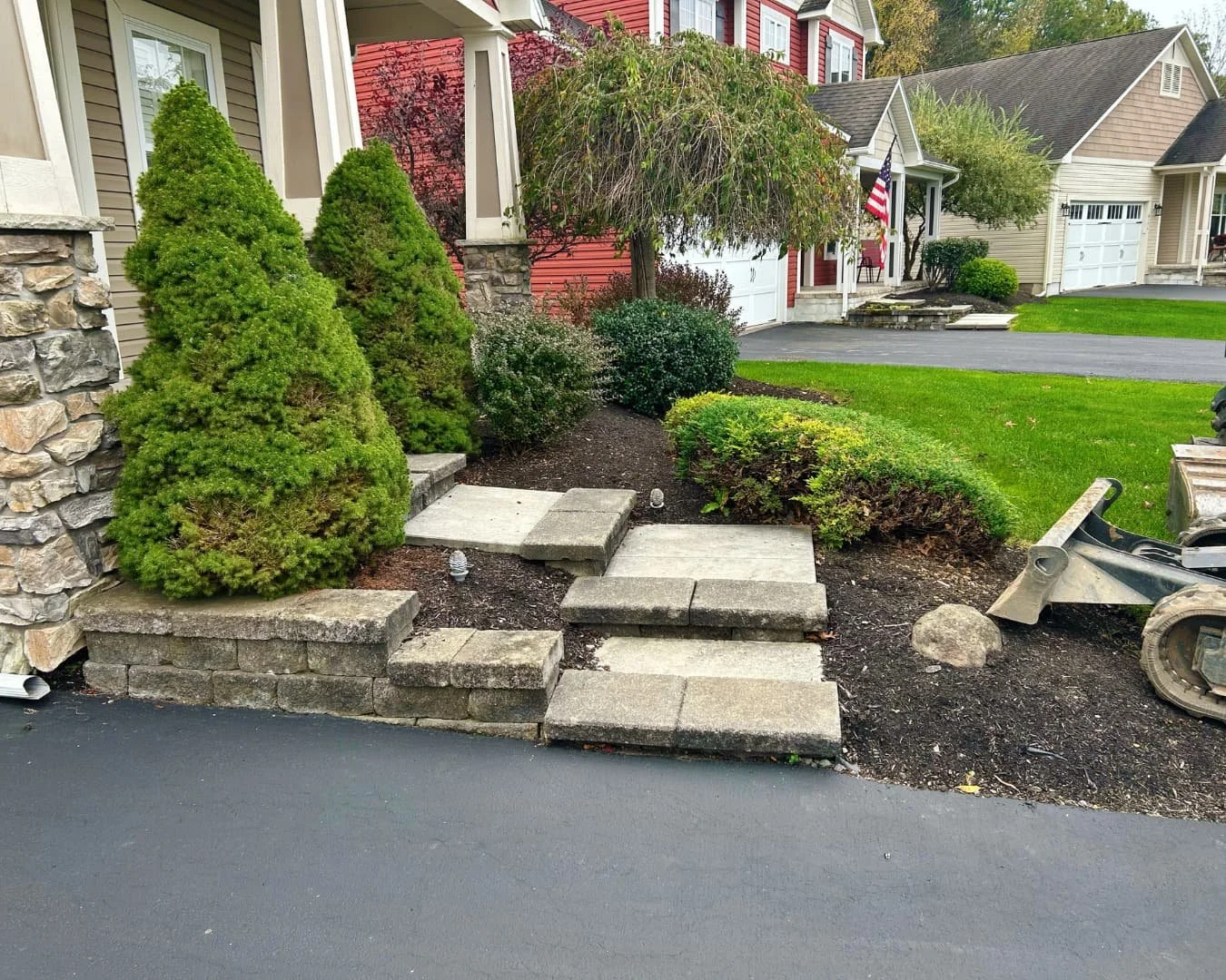 Front entry hardscape and planting bed completed by Pines and Pavers in Skaneateles Falls, New York.