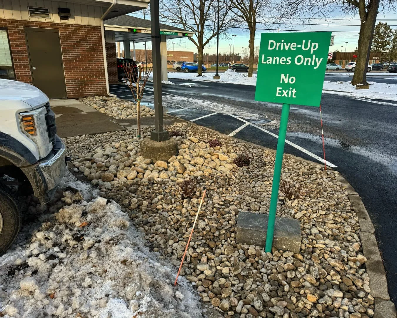 Rock island and sign detail at Citizens Bank completed by Pines and Pavers in Cicero, New York.