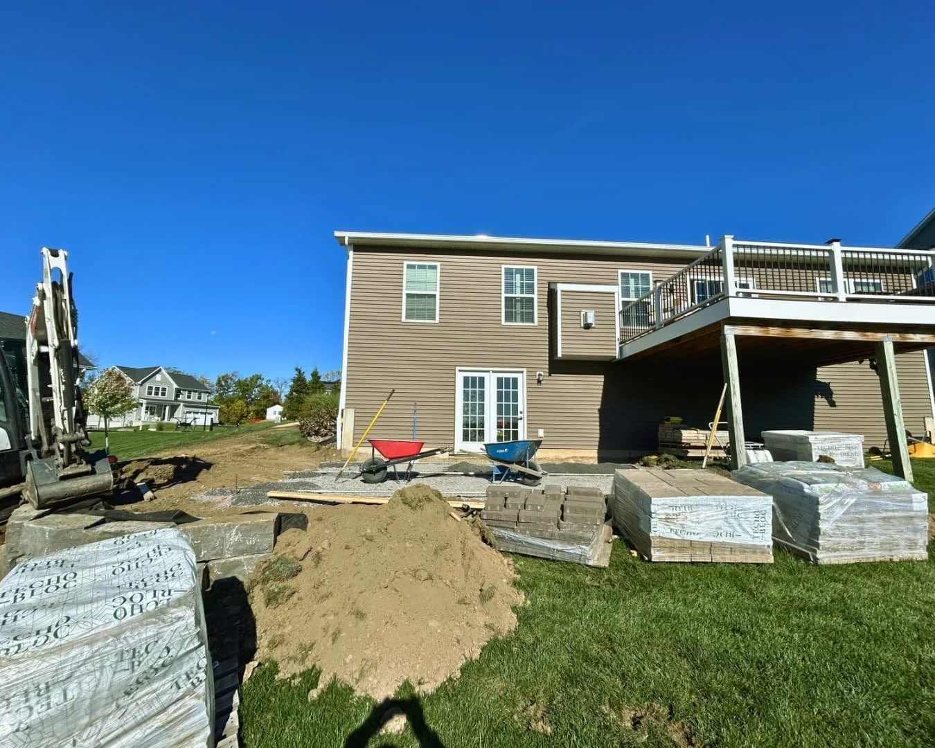 Paver patio and side yard hardscape design installed beside a home in Upstate New York.