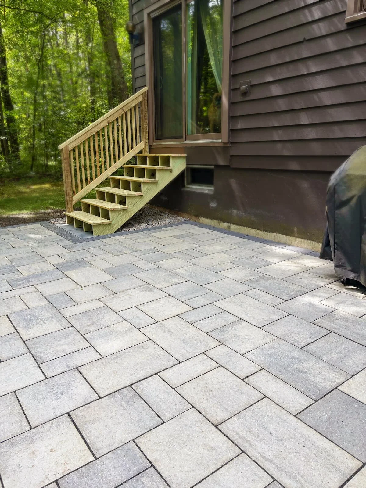 Custom paver patio installation beside a home in Central New York.
