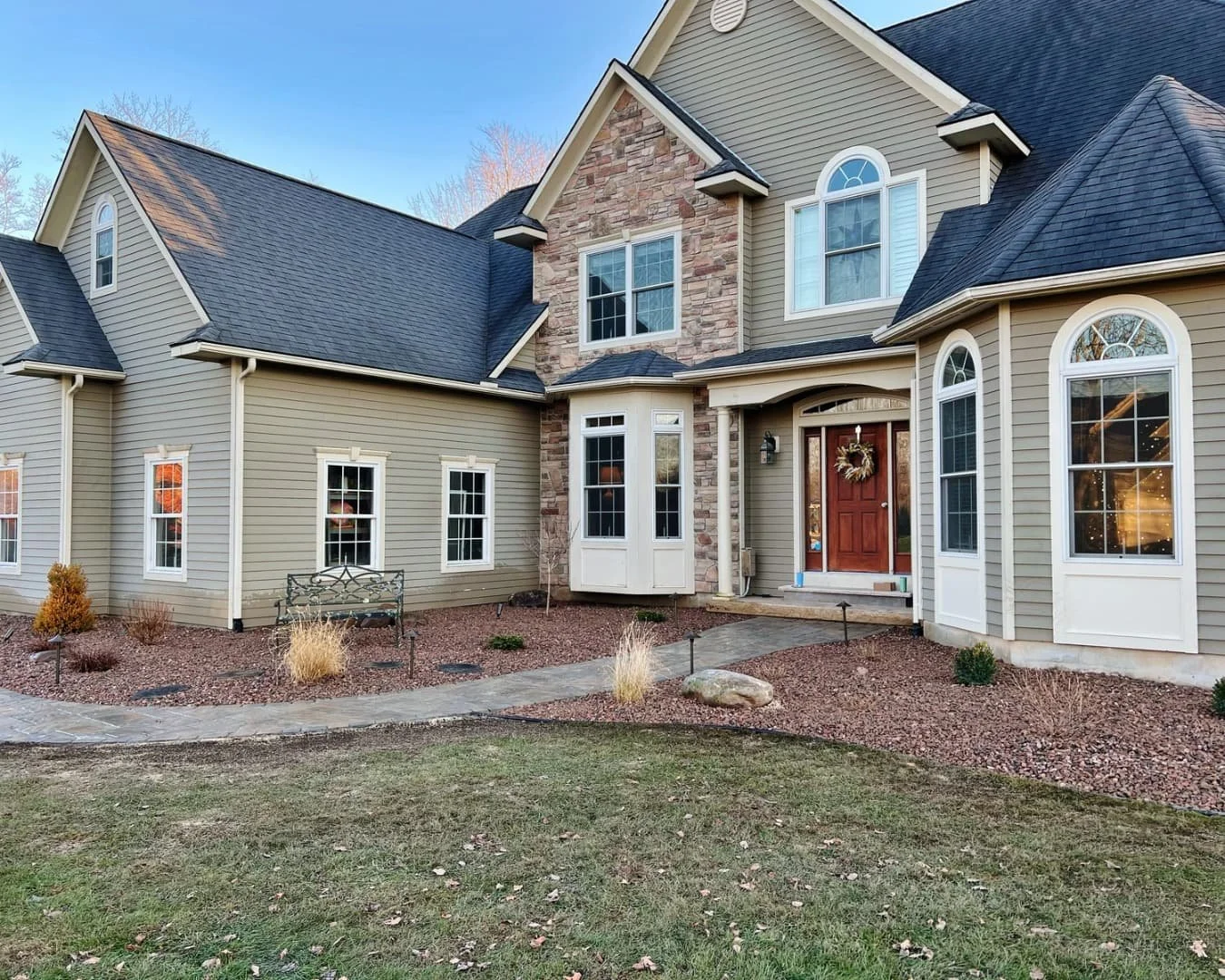 Wide view of the front home exterior before the project by Pines and Pavers in Fayetteville, New York.