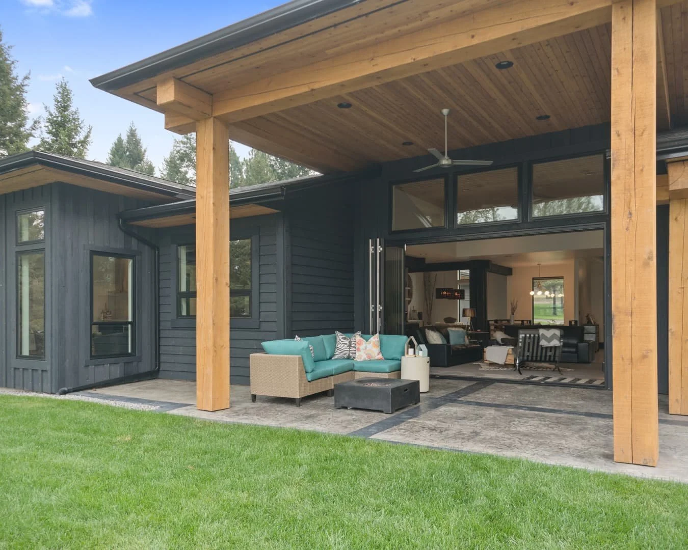 Covered patio inspiration with wood posts, outdoor seating, and an open backyard connection.