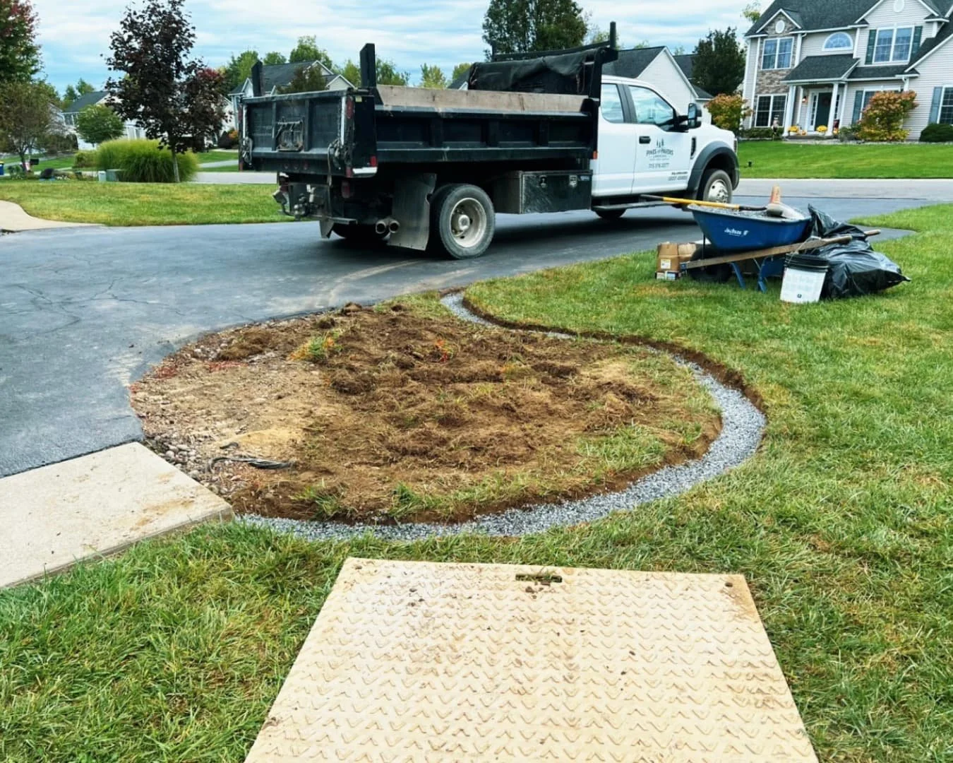 Side yard landscape refresh at a Central New York home with fresh mulch, shaped beds, and clean lawn edges.
