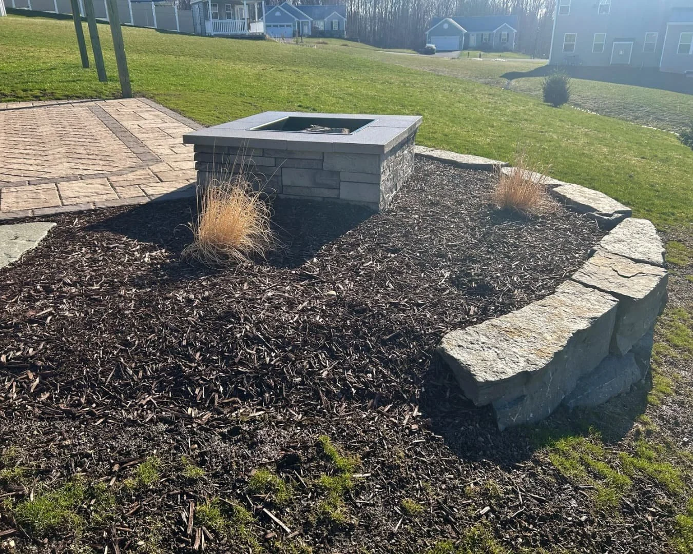 Paver patio with seating wall detail completed by Pines and Pavers in Lysander, New York.