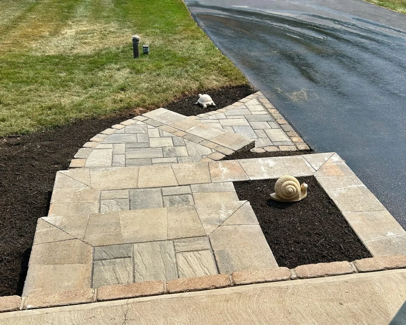 Front walkway and landscape border completed by Pines and Pavers in Manlius, New York.