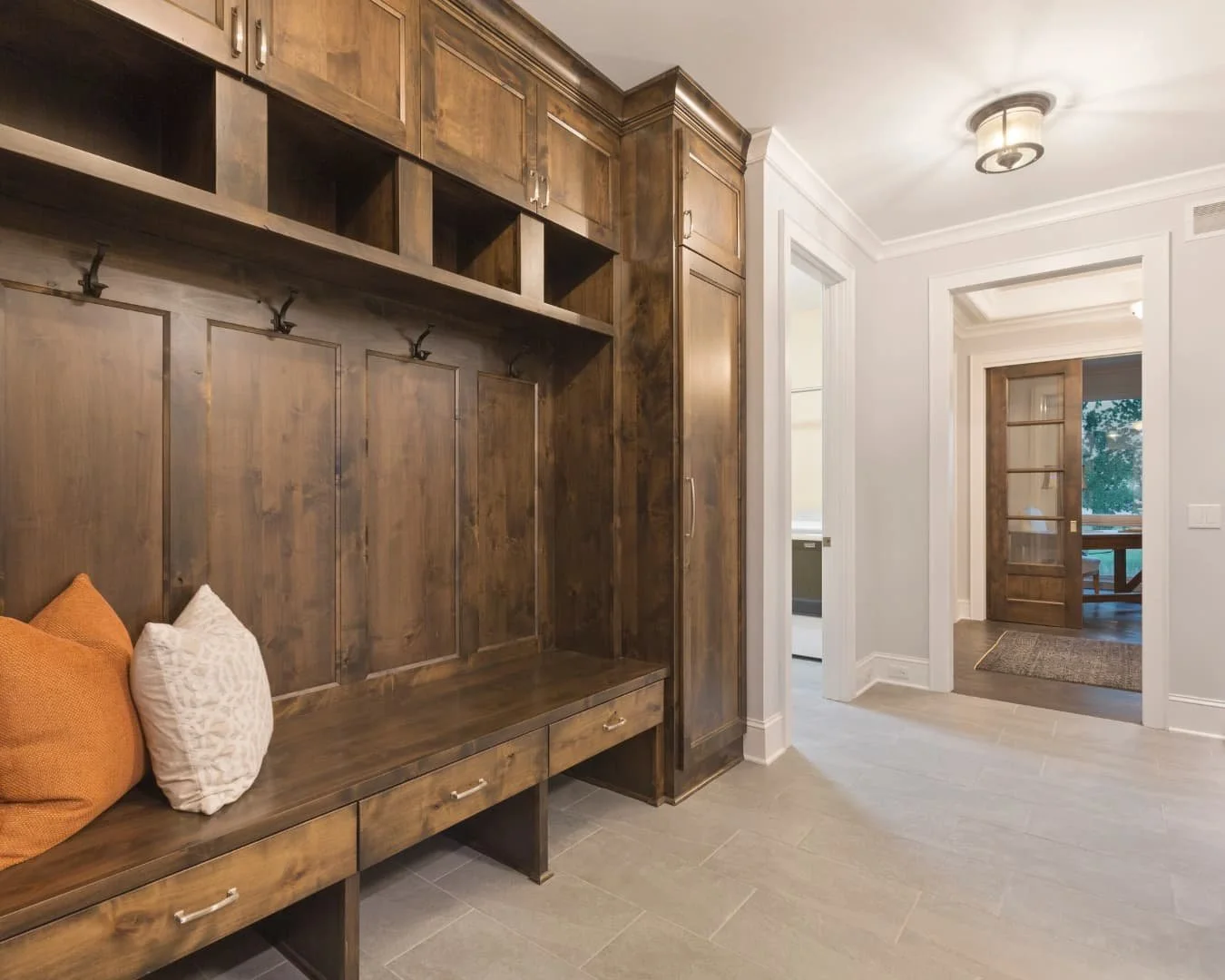 Mudroom inspiration featuring open shelving, bench seating, and a bright organized entry layout.