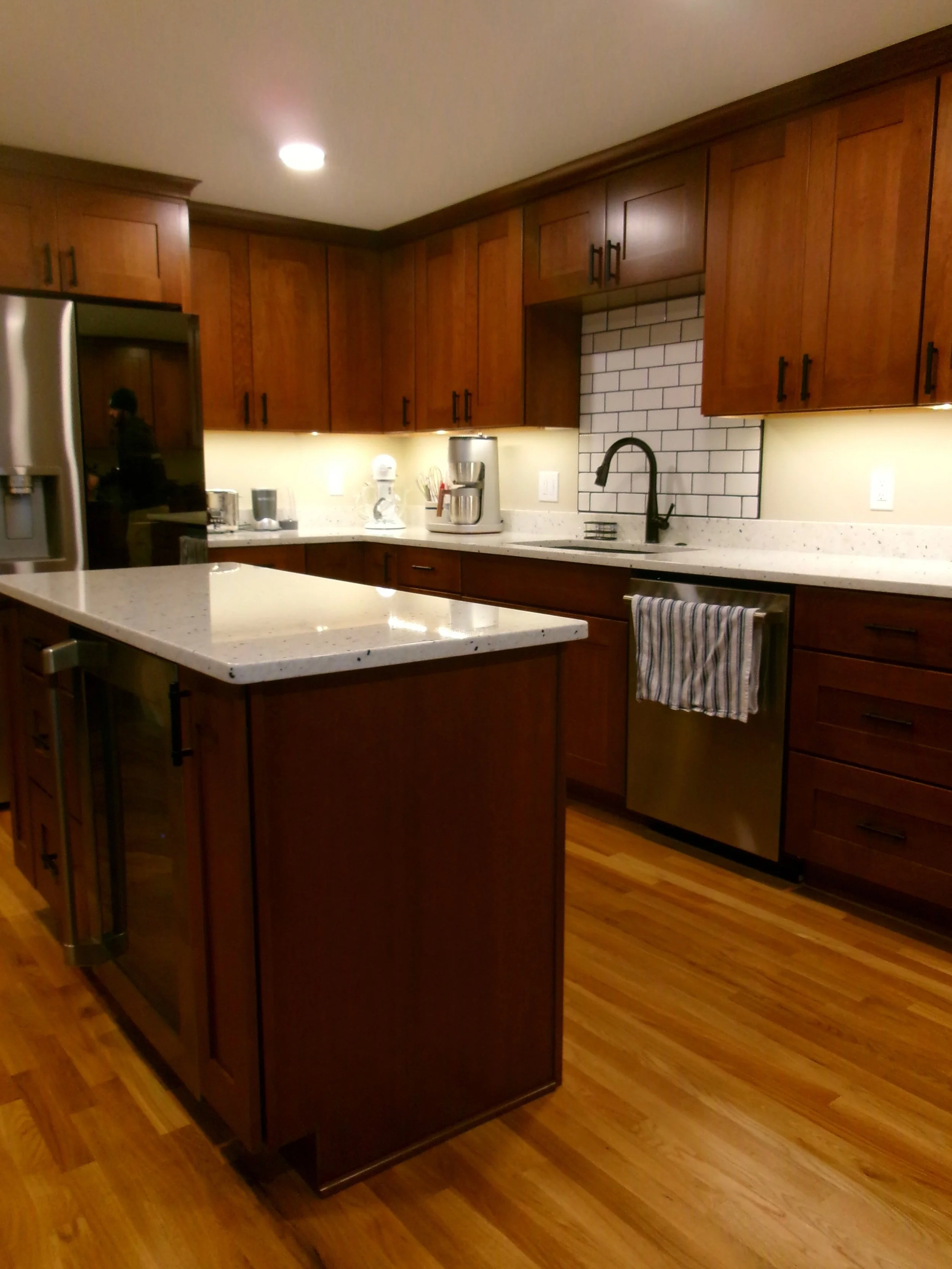 Modern outdoor kitchen with dark cabinetry and stone countertops in Central New York.