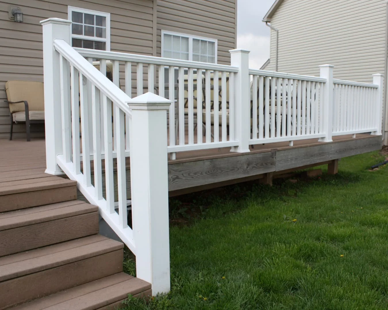 Deck inspiration featuring white railing, stairs, and a clean elevated entry connection to the yard.