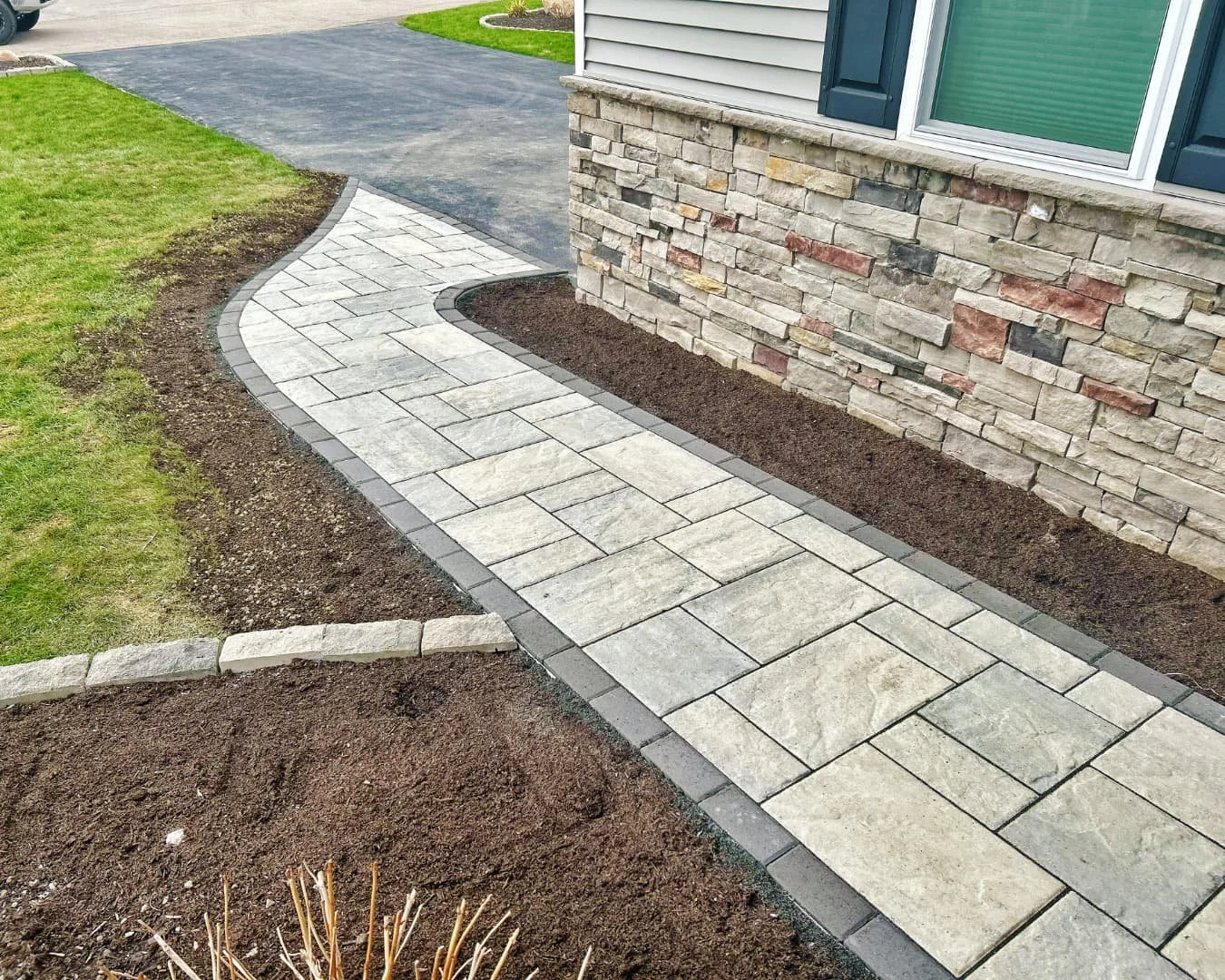     New concrete front entry walkway connecting the driveway to the front door of a residential home.