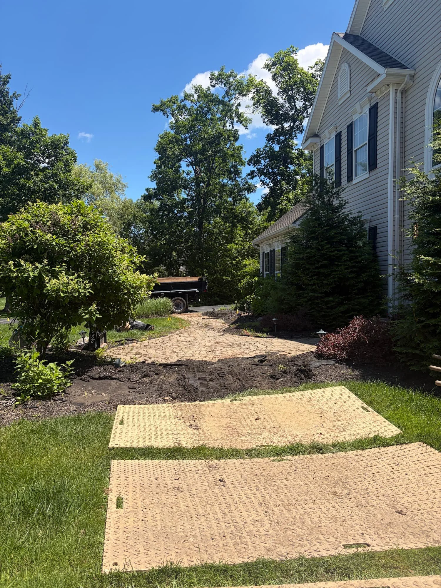 Paver walkway construction in progress beside a residential home in Central NY.