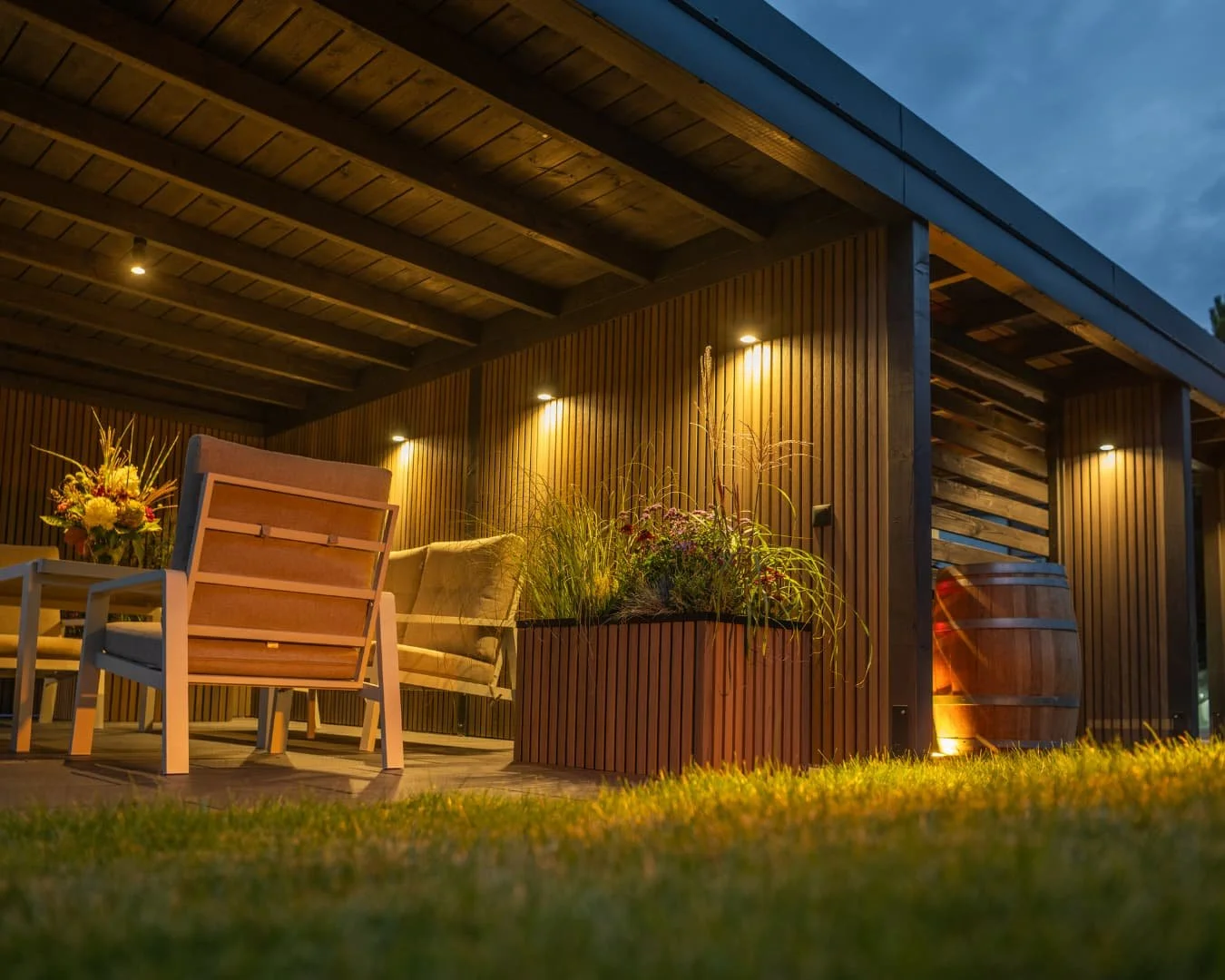 Outdoor lighting inspiration featuring a covered structure lit with warm exterior accent lighting.